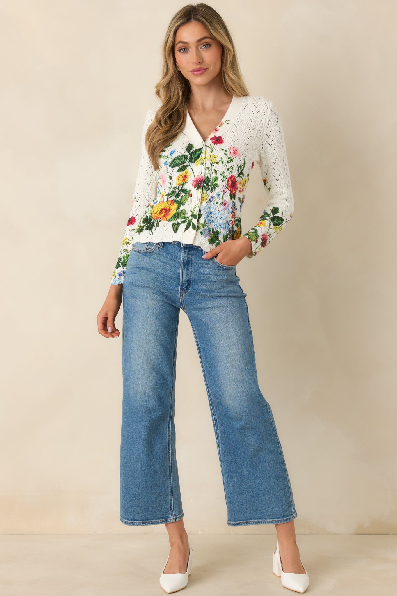 Ivory pointelle knit cardigan shown from the front, highlighting the floral print across the body and sleeves.