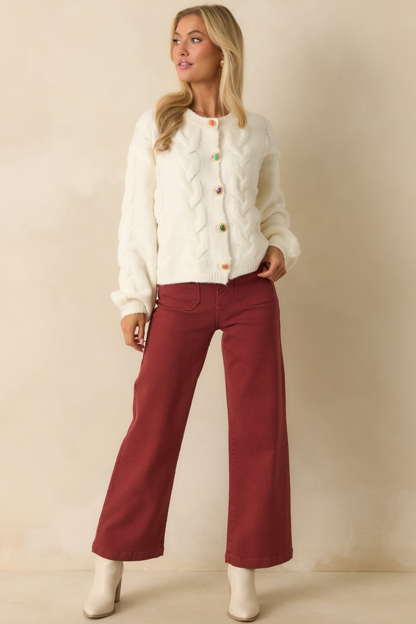 Front view of ivory cardigan featuring cozy midweight yarn, long sleeves, and decorative multicolor buttons.