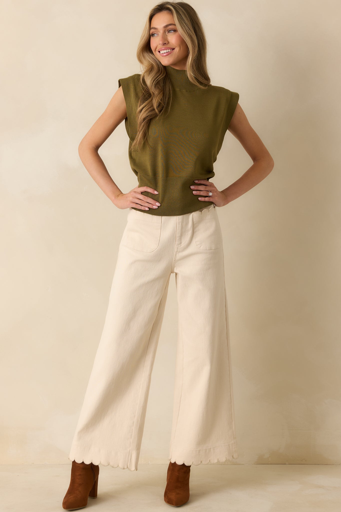 Front-facing ivory wide-leg pants with high-waisted fit, scalloped-trim patch pockets, and flowing structured legs.
