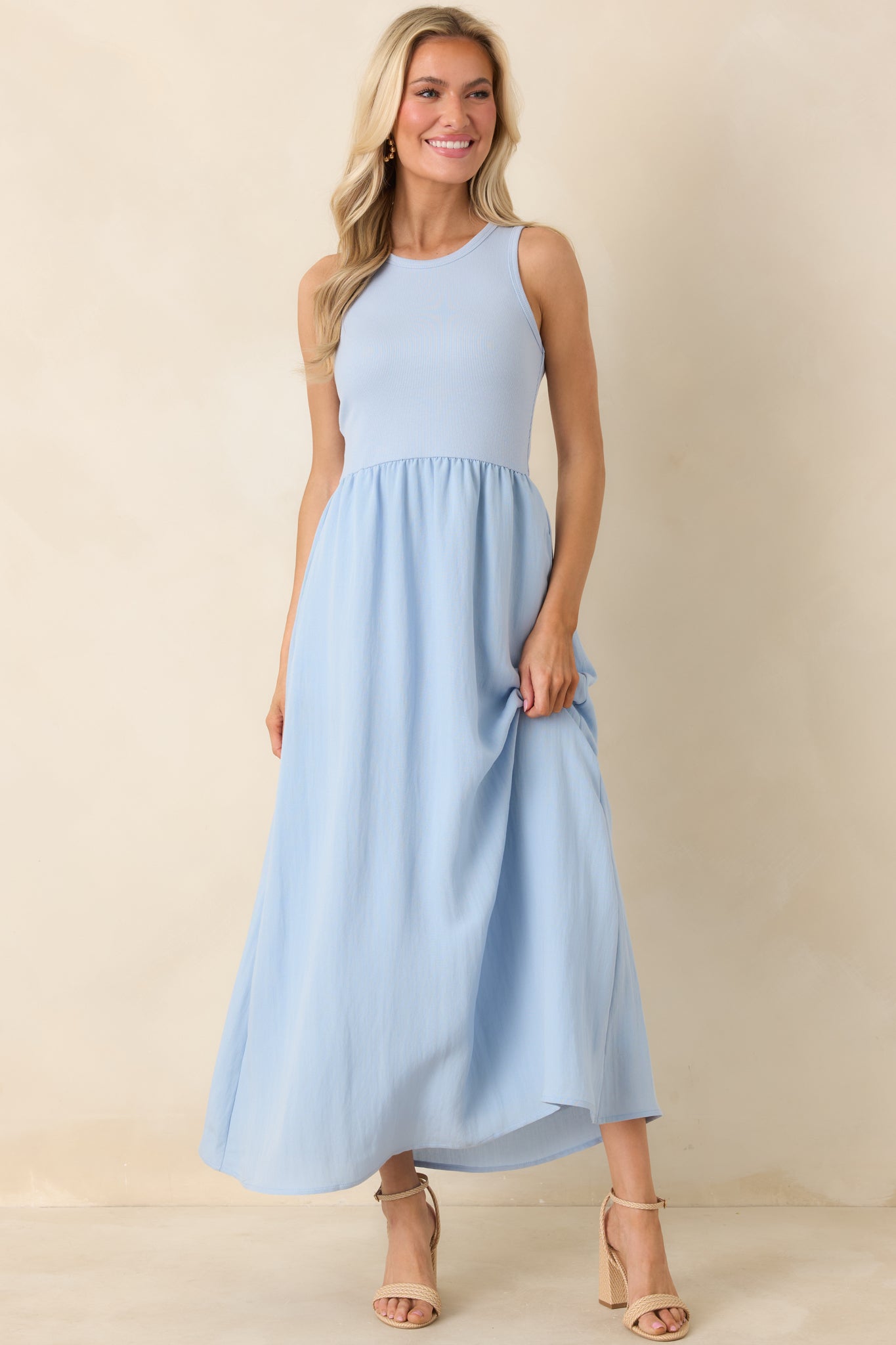Front view of the sleeveless light blue midi dress showing a relaxed fit and ribbed top detail.