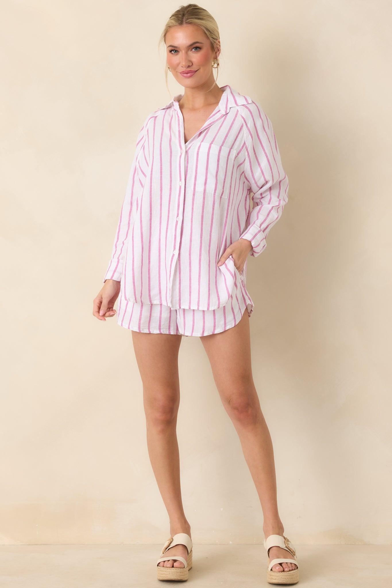 Front view of lightweight linen button-down top with soft rose pink stripes on a natural background and relaxed fit.