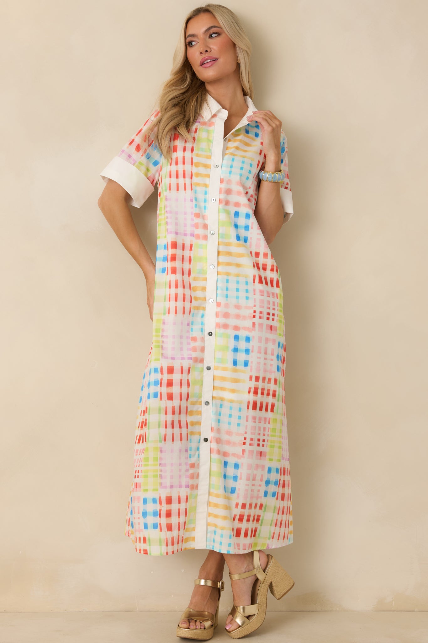 Front view of maxi dress with multicolor check print, collared neckline, and button-front closure.