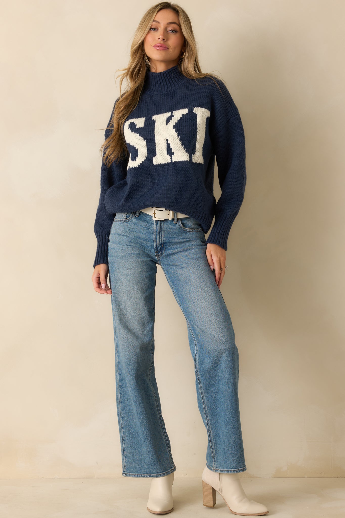 Front view of medium wash wide-leg jeans with functional belt loops and full-length legs.