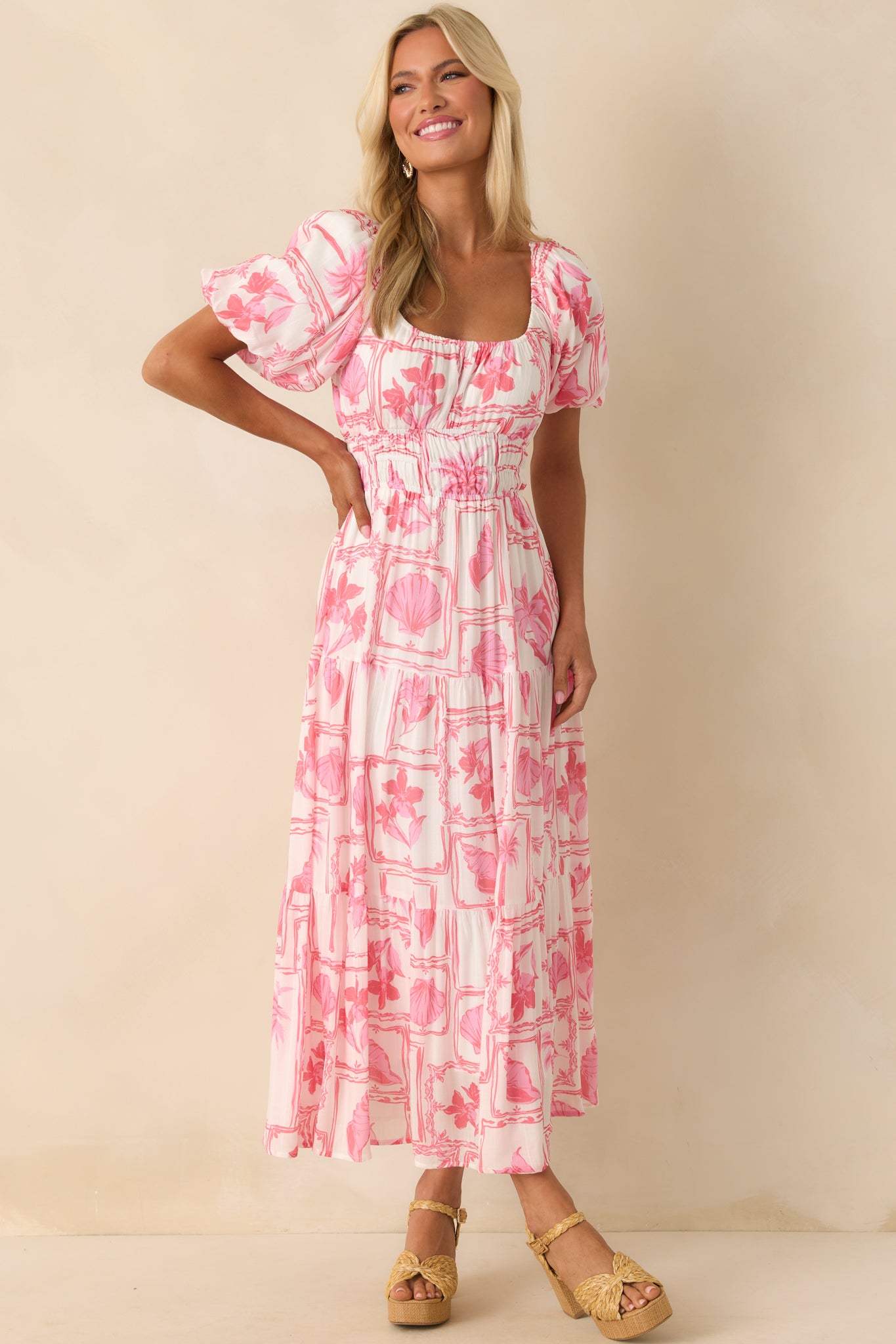 Front view of the midi dress featuring a pink tropical postcard print, elastic scooped neckline, and short puff sleeves.