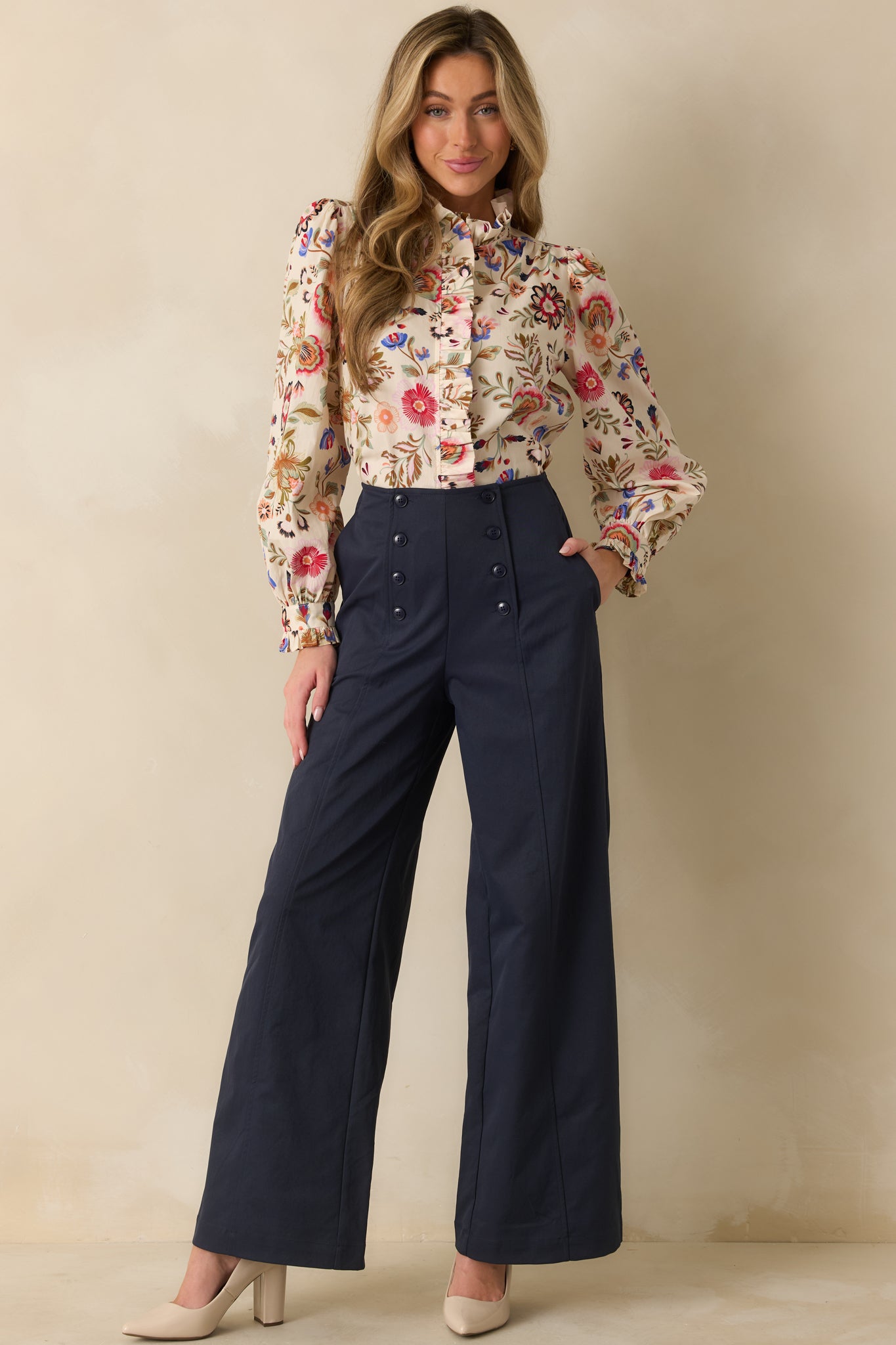 Front view of navy high-waist pants showing structured wide-leg shape and elongating fit.