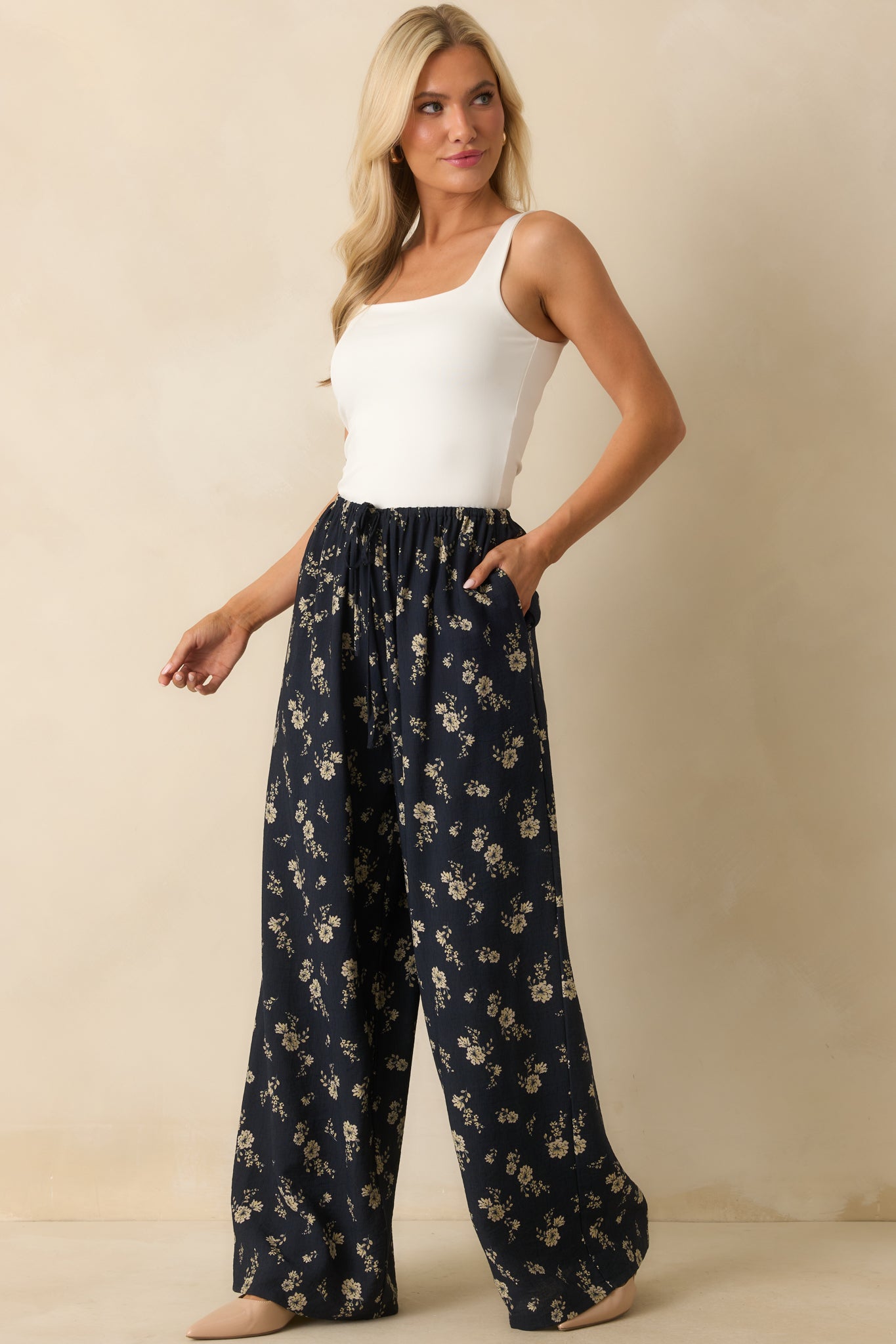 Front view of the navy pants, emphasizing the flowing wide-leg silhouette and high-rise fit.