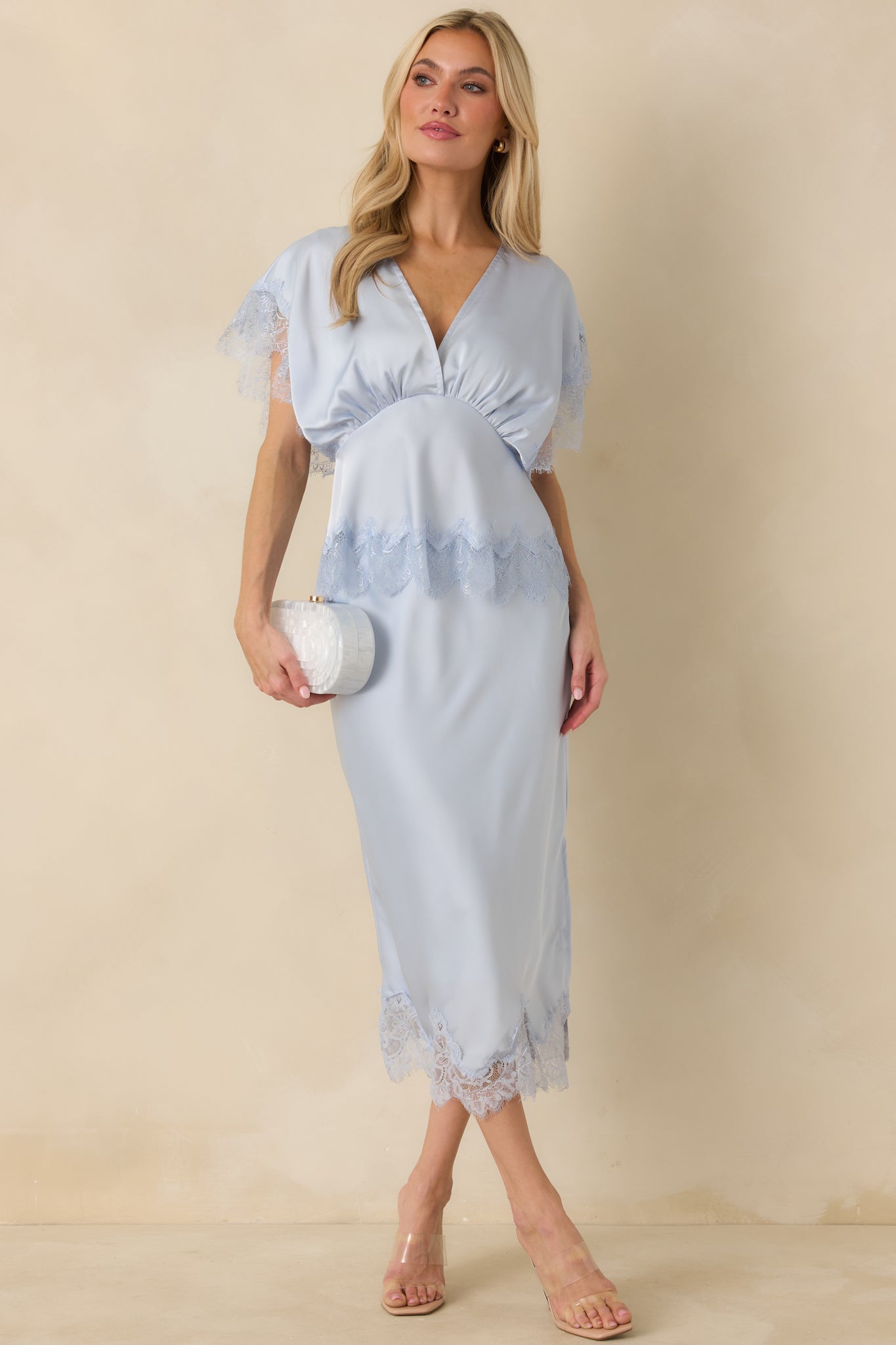 Front view of a blue satin midi skirt with a straight silhouette and scalloped lace-trim hem.