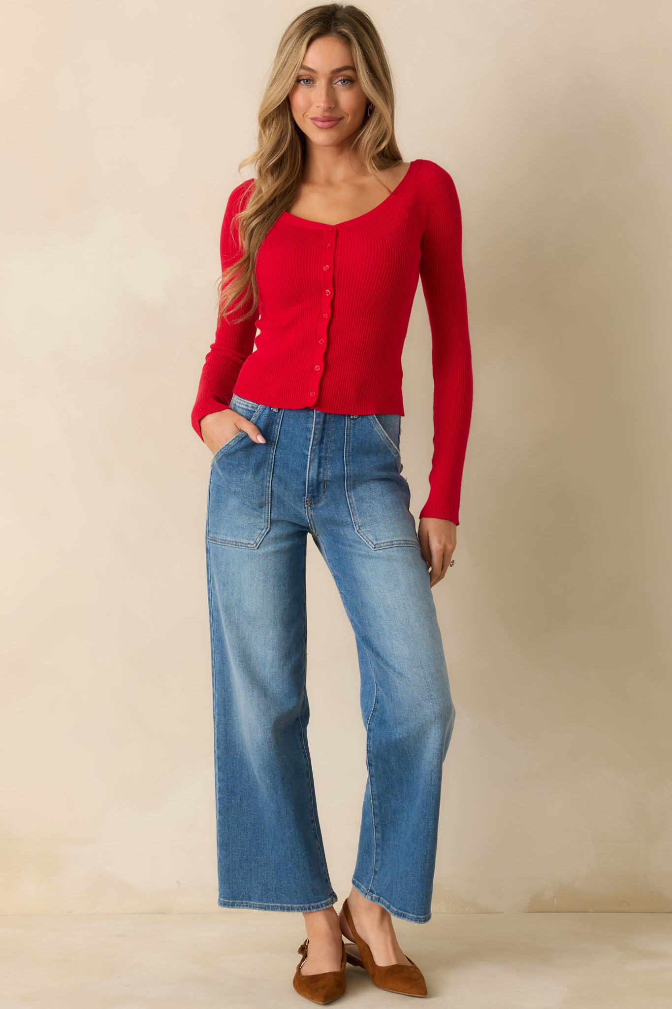 Front view of red ribbed sweater with button-front placket, cropped fit, and cozy knit texture.