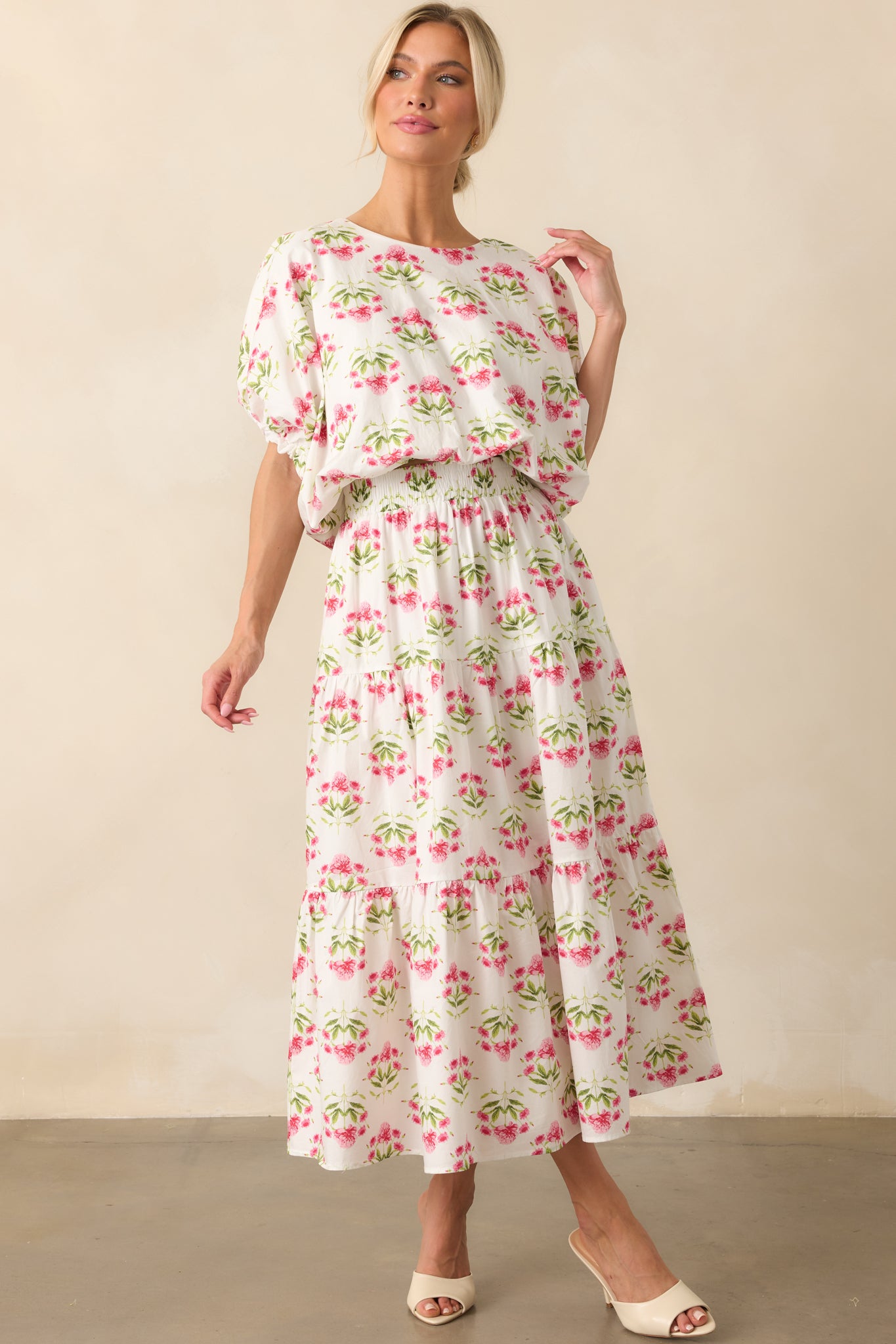 Complete front view of the cropped top, showcasing the floral pattern and voluminous sleeve design.