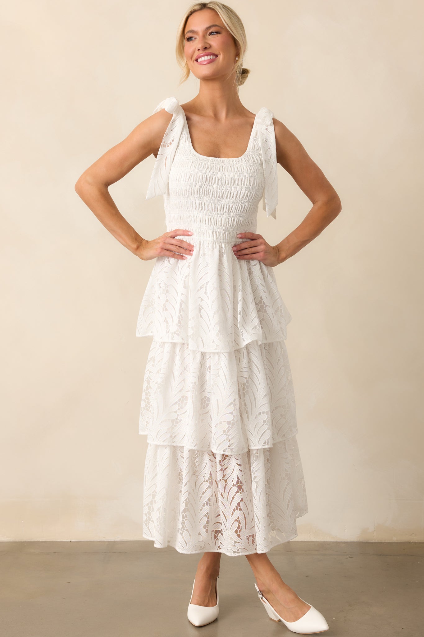 A front-facing view of the ivory maxi dress, highlighting the intricate lace detailing, smocked fit, and graceful tiered skirt.