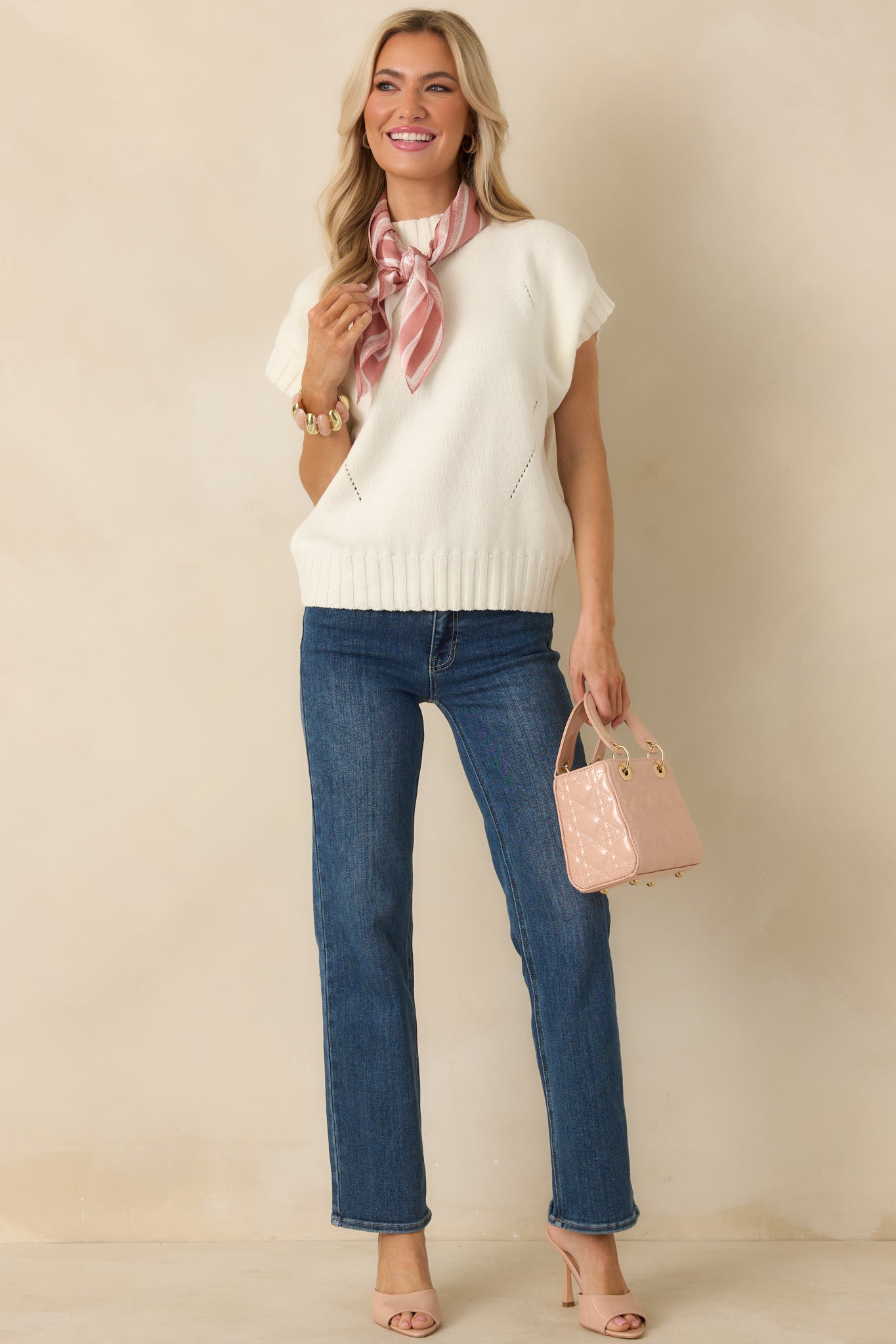 Full body front view of the ivory sweater showing the mock neckline, short sleeves, and relaxed boxy silhouette.