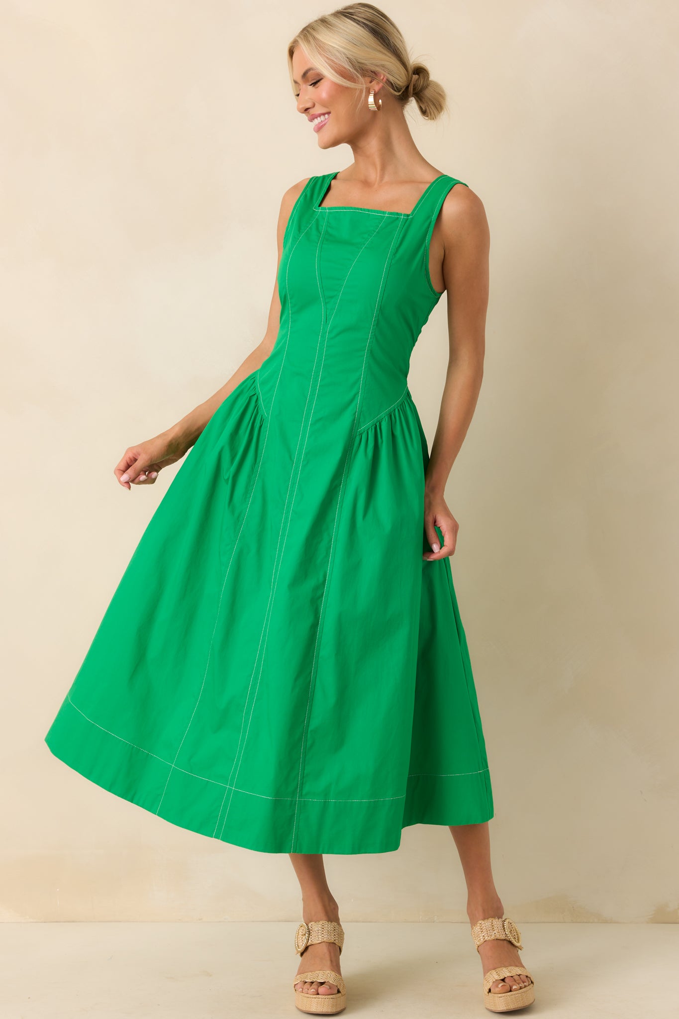 Full body front view of the kelly green midi dress featuring a square neckline, sleeveless design, and basque-inspired drop waist.