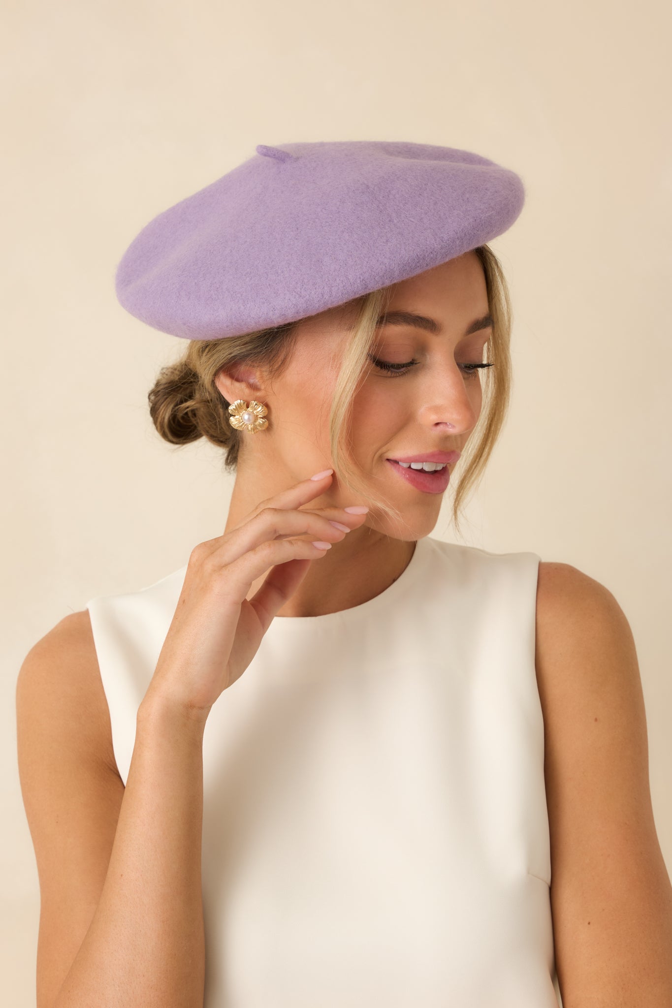 Cropped front view of the lavender beret featuring a smooth, structured wool fabric and classic round silhouette.