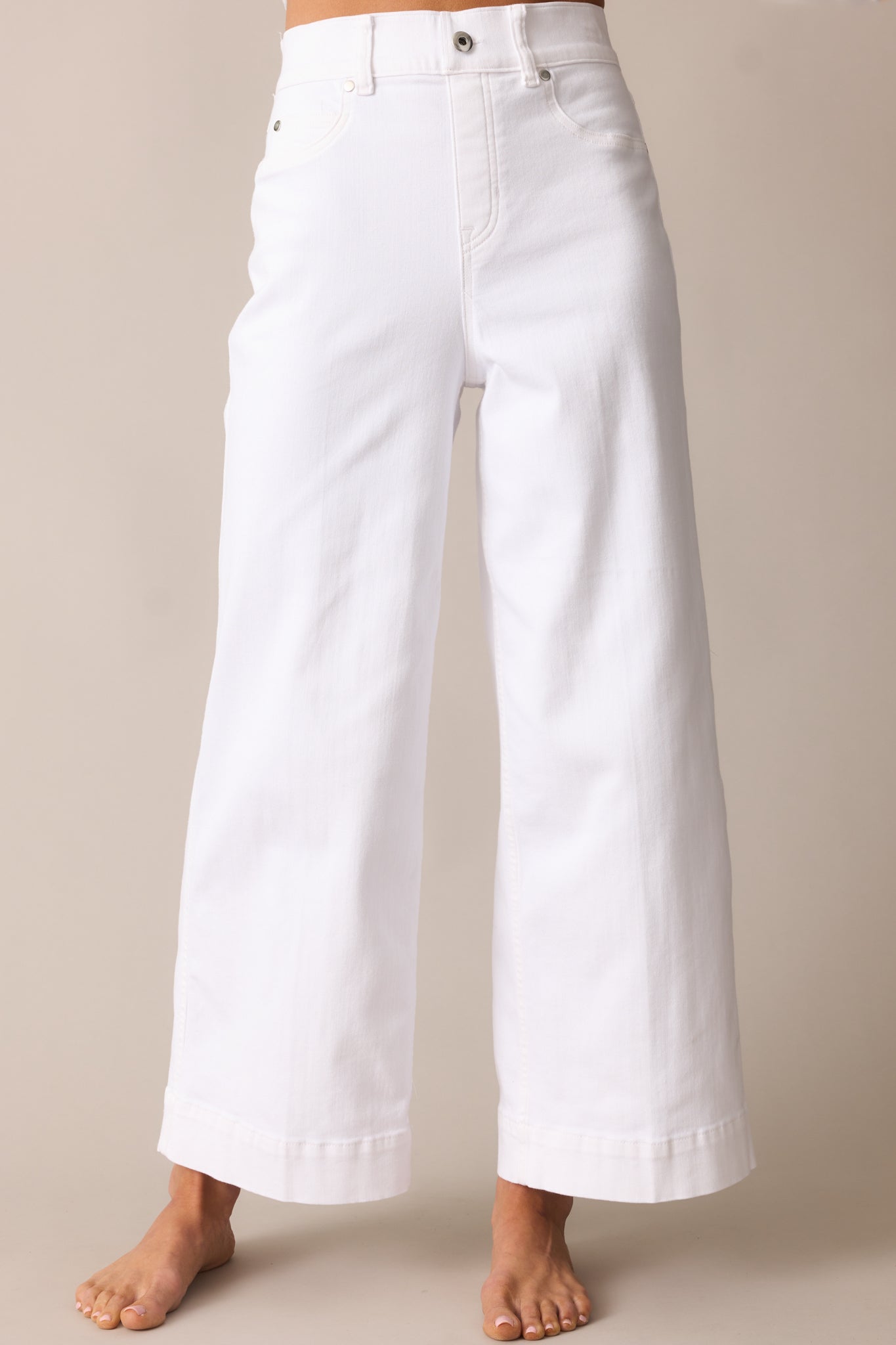 Cropped front view of the waistband area showing the faux front button and flat faux pockets.