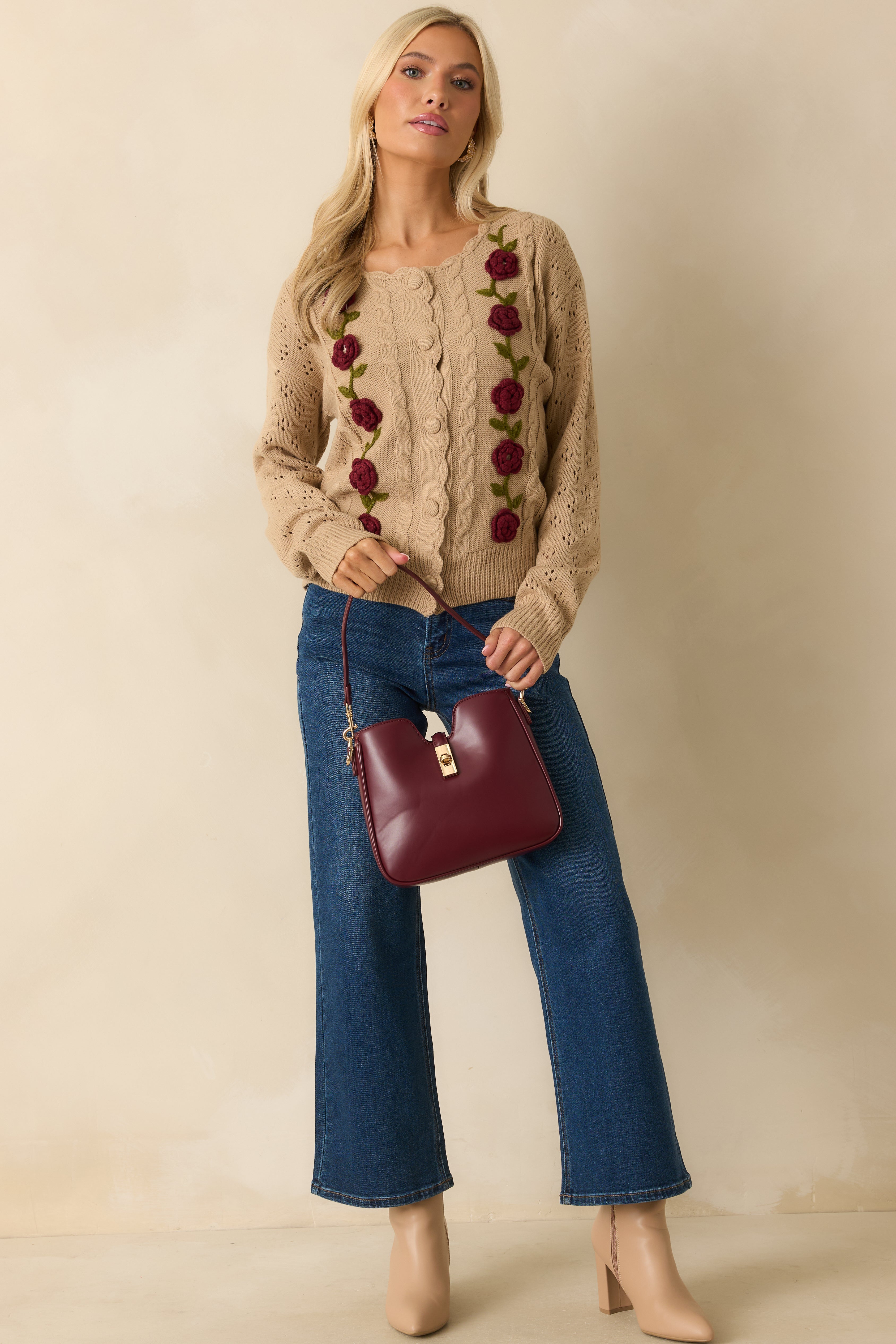 Straight front view emphasizing the openwork knit sleeves and relaxed silhouette.