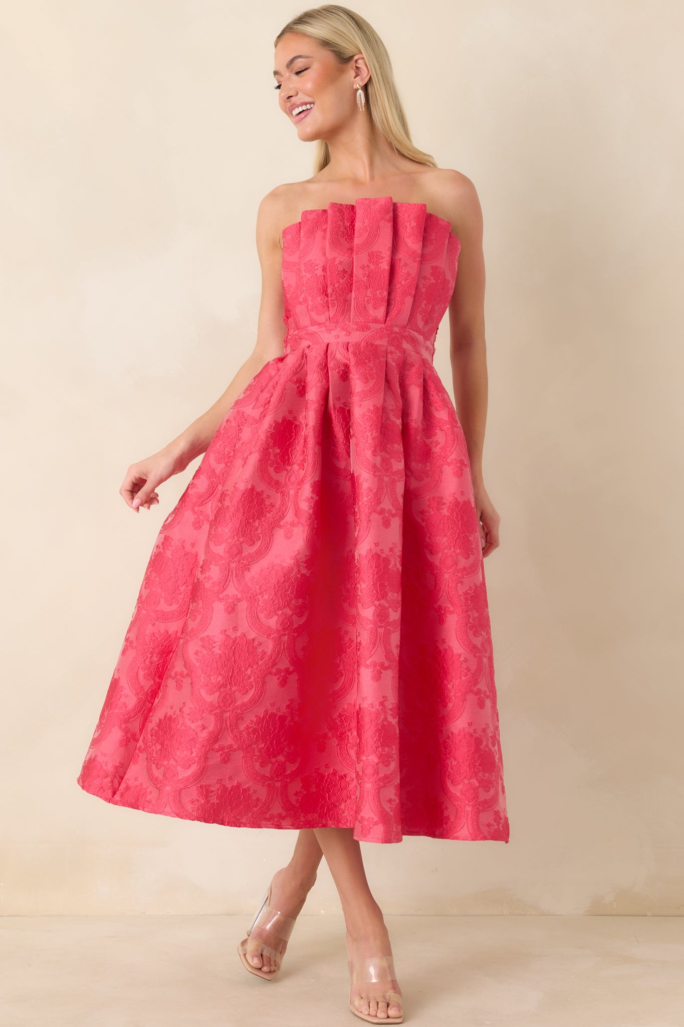 Front view of pink strapless jacquard midi dress featuring a pleated bodice and softly pleated skirt.