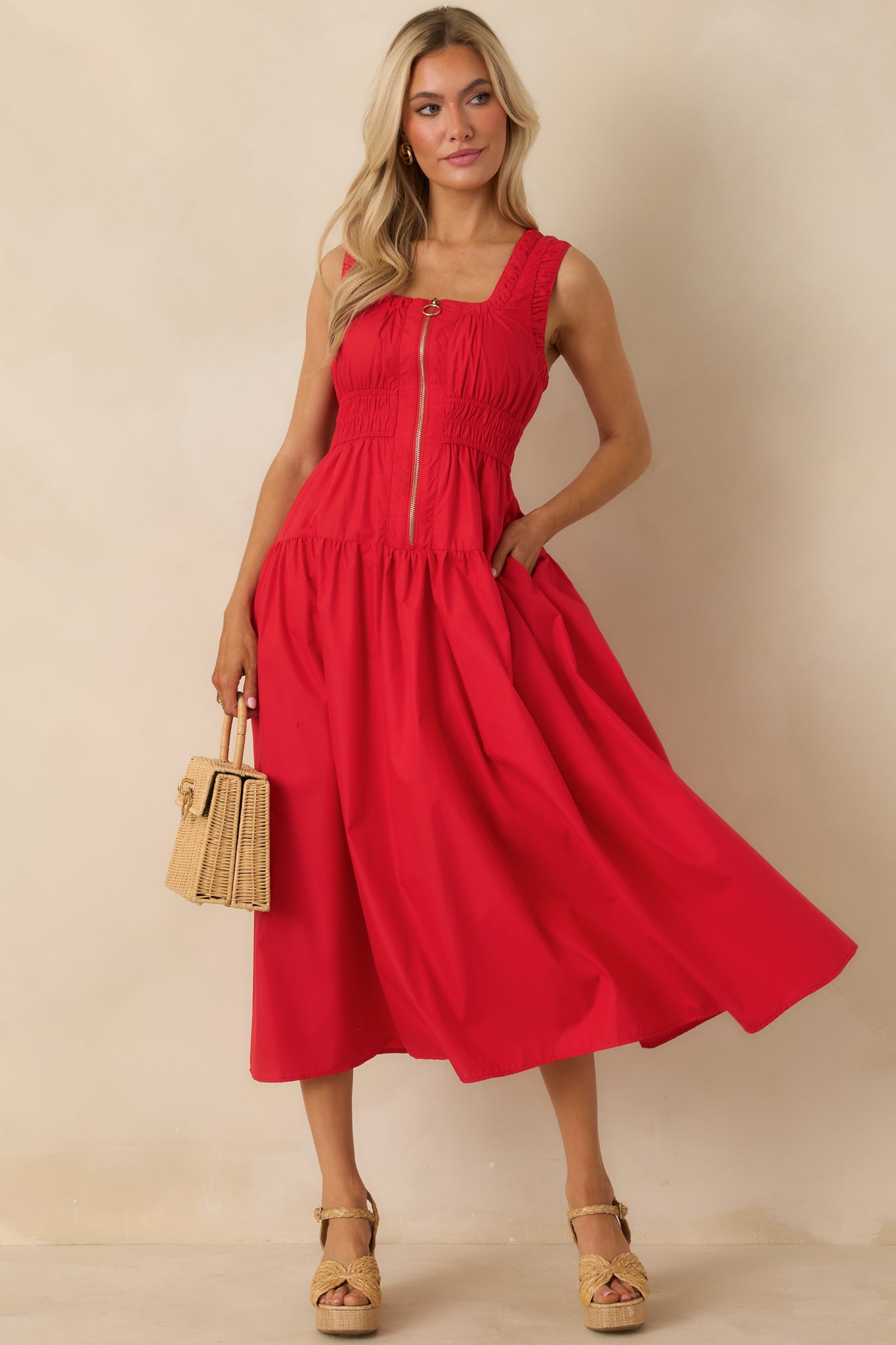 Front view of red midi dress showing scoop neckline, o-ring zip front, and sleeveless design.