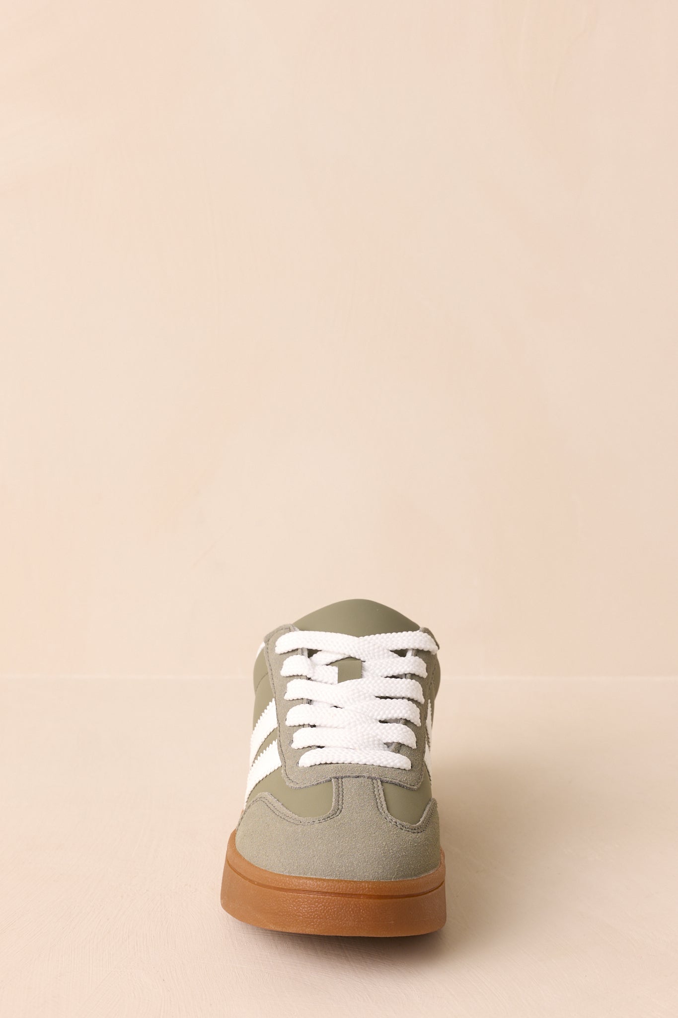A straight-on front view of the sneaker highlighting its rounded toe shape and gum rubber sole.
