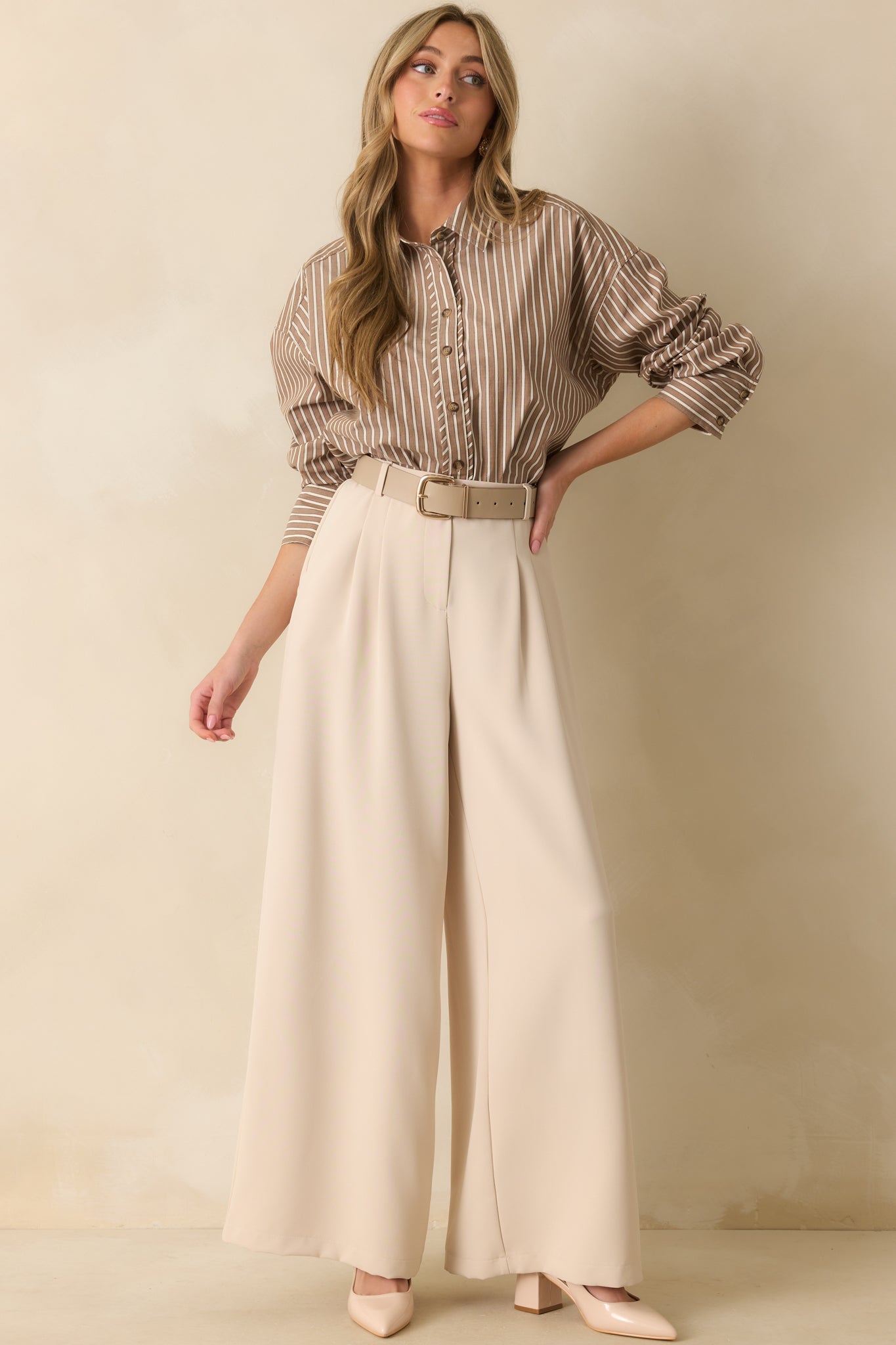 Front view of shirt featuring relaxed fit, button cuffs, and scoop bottom hem.