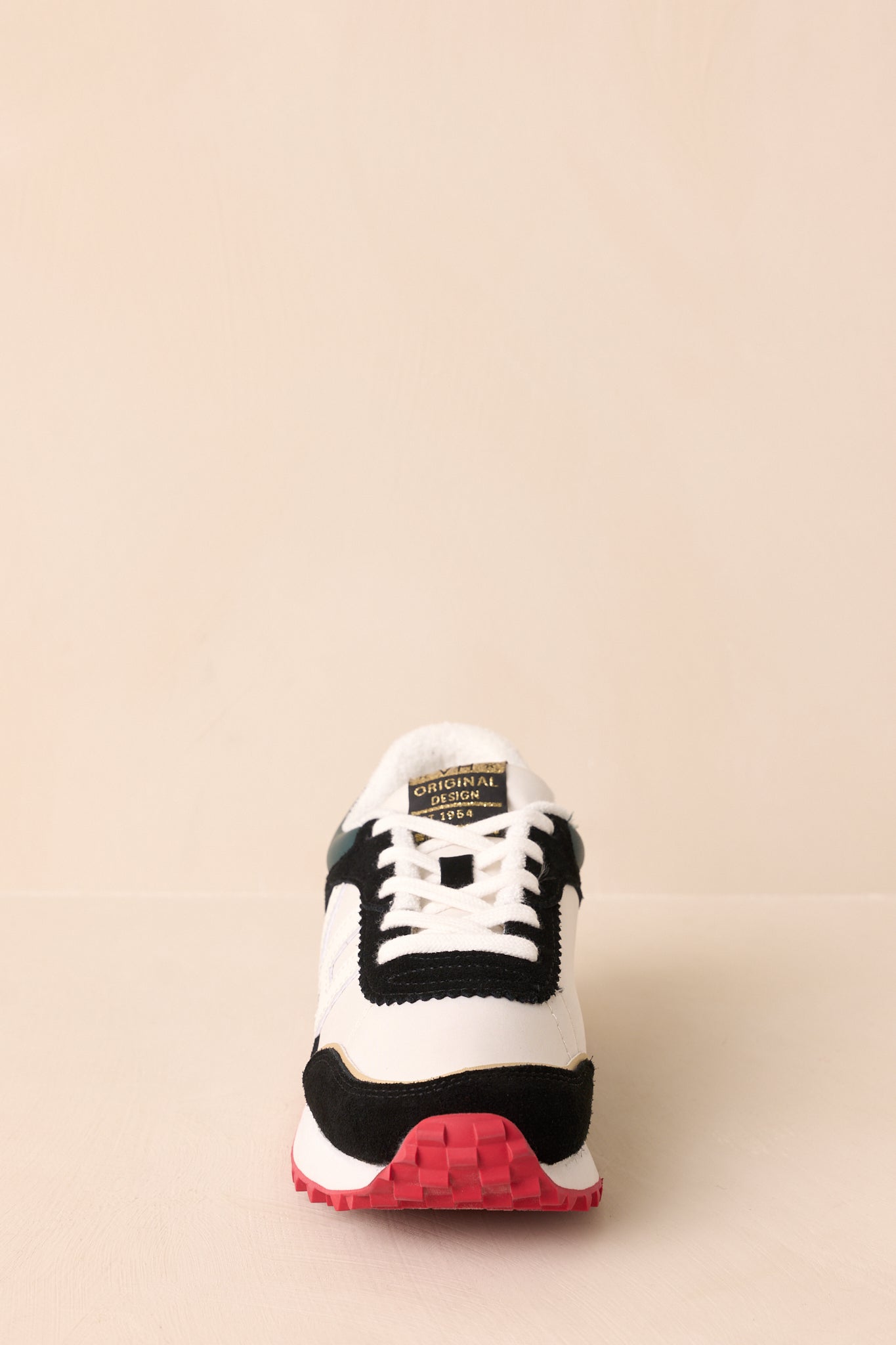 Front-facing view of the sneakers showcasing the lace-up design and sleek modern shape.