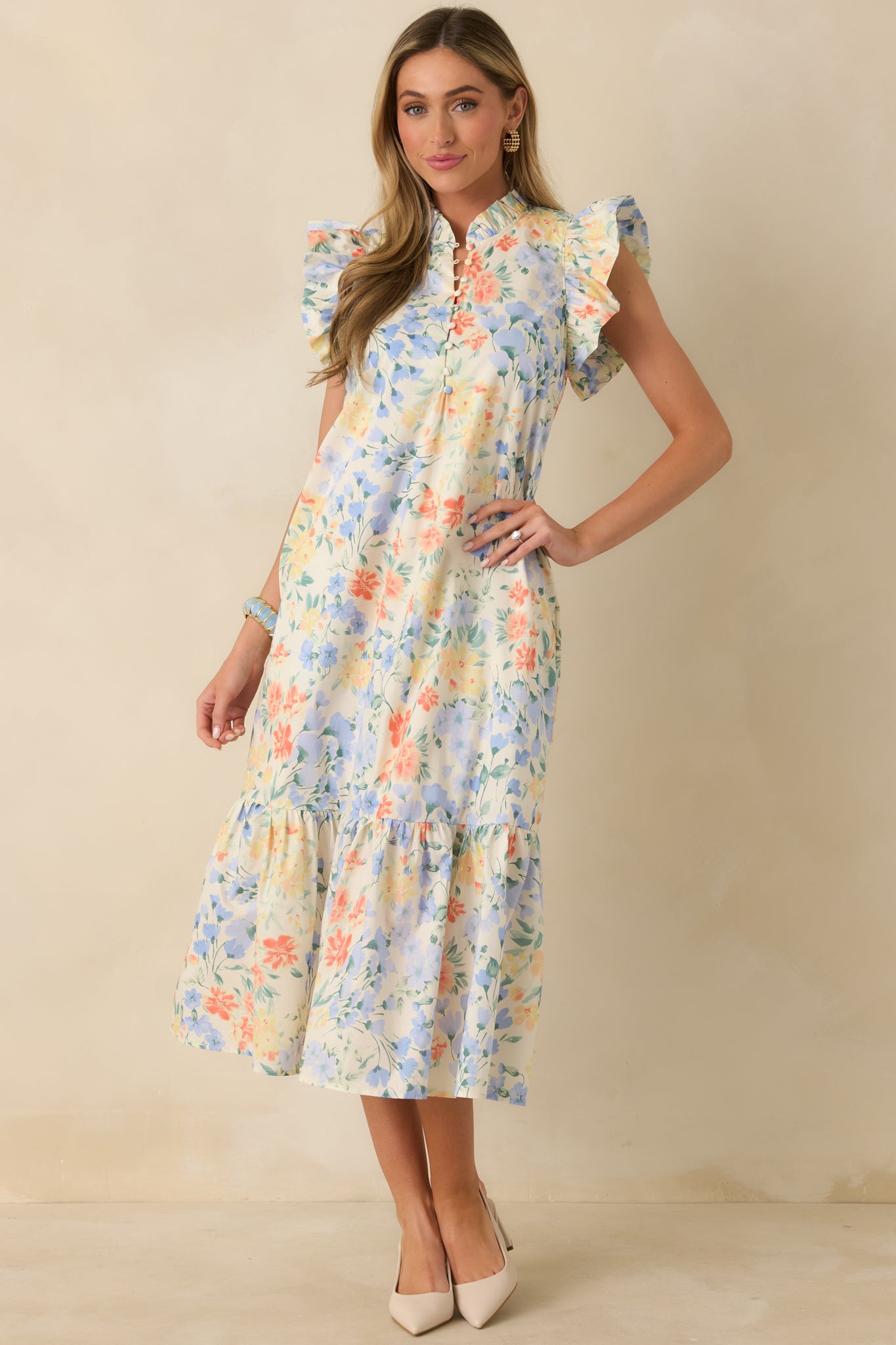 Full-length front view showcasing the soft stand collar, relaxed fit, and feminine flutter sleeves.