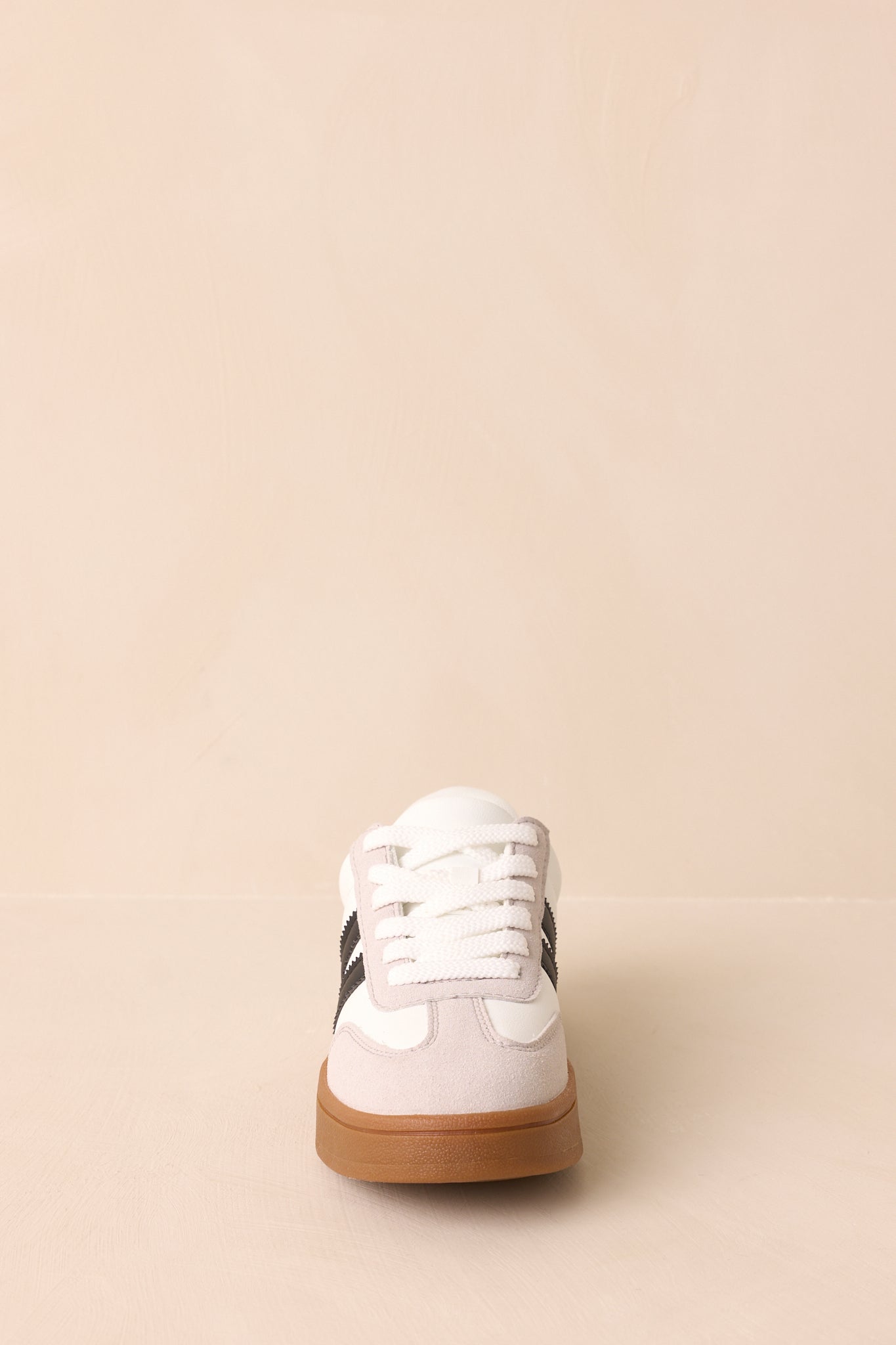 A straight-on front view of the sneaker highlighting its lace-up front, round toe, and gum rubber sole.