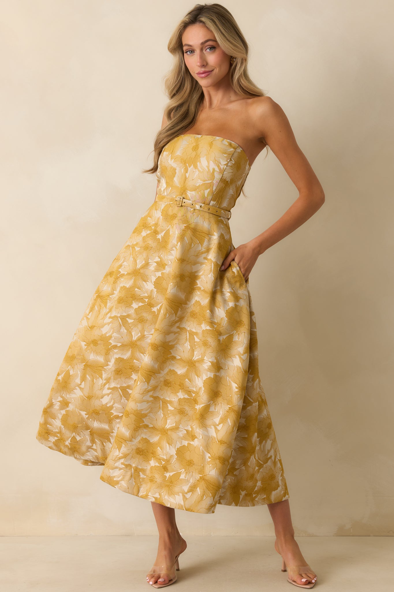 Front view of strapless yellow gold dress highlighting smooth fabric and midi length.