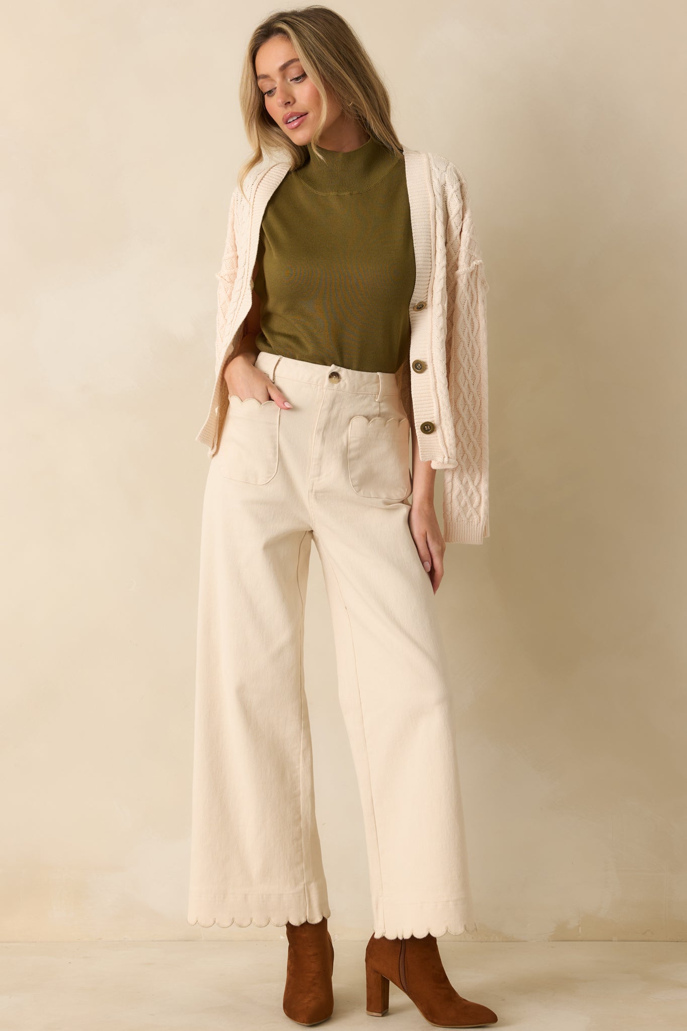 Front view showing structured waistband and soft olive green knit fabric.