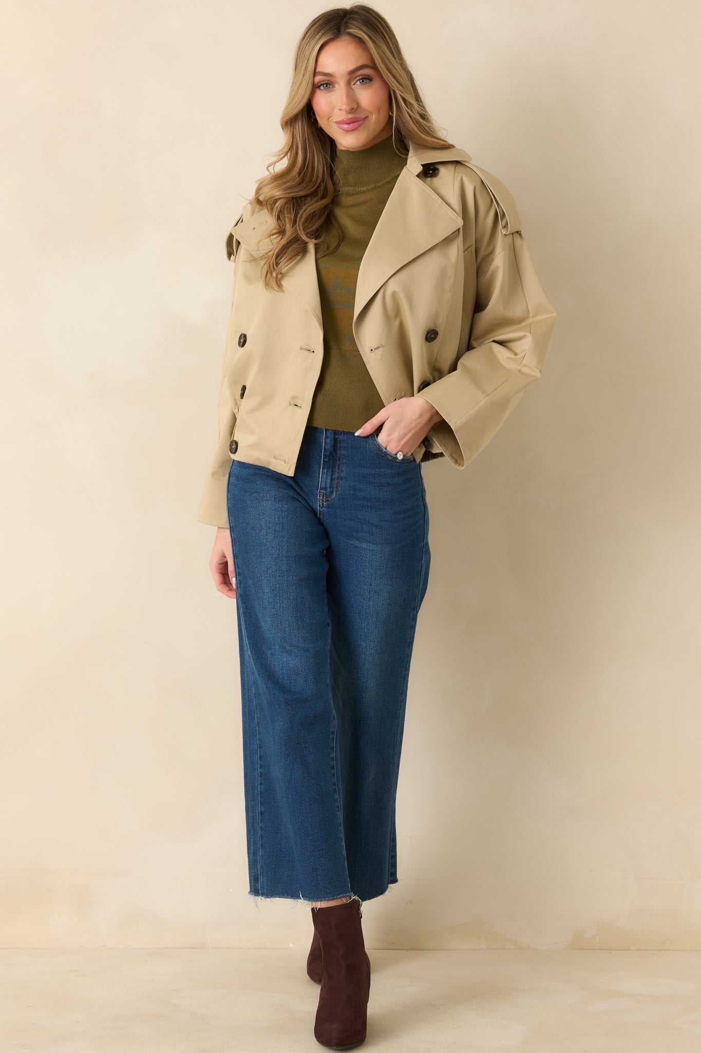 Front view of tan cropped cotton jacket with double-breasted buttons and notched lapels.