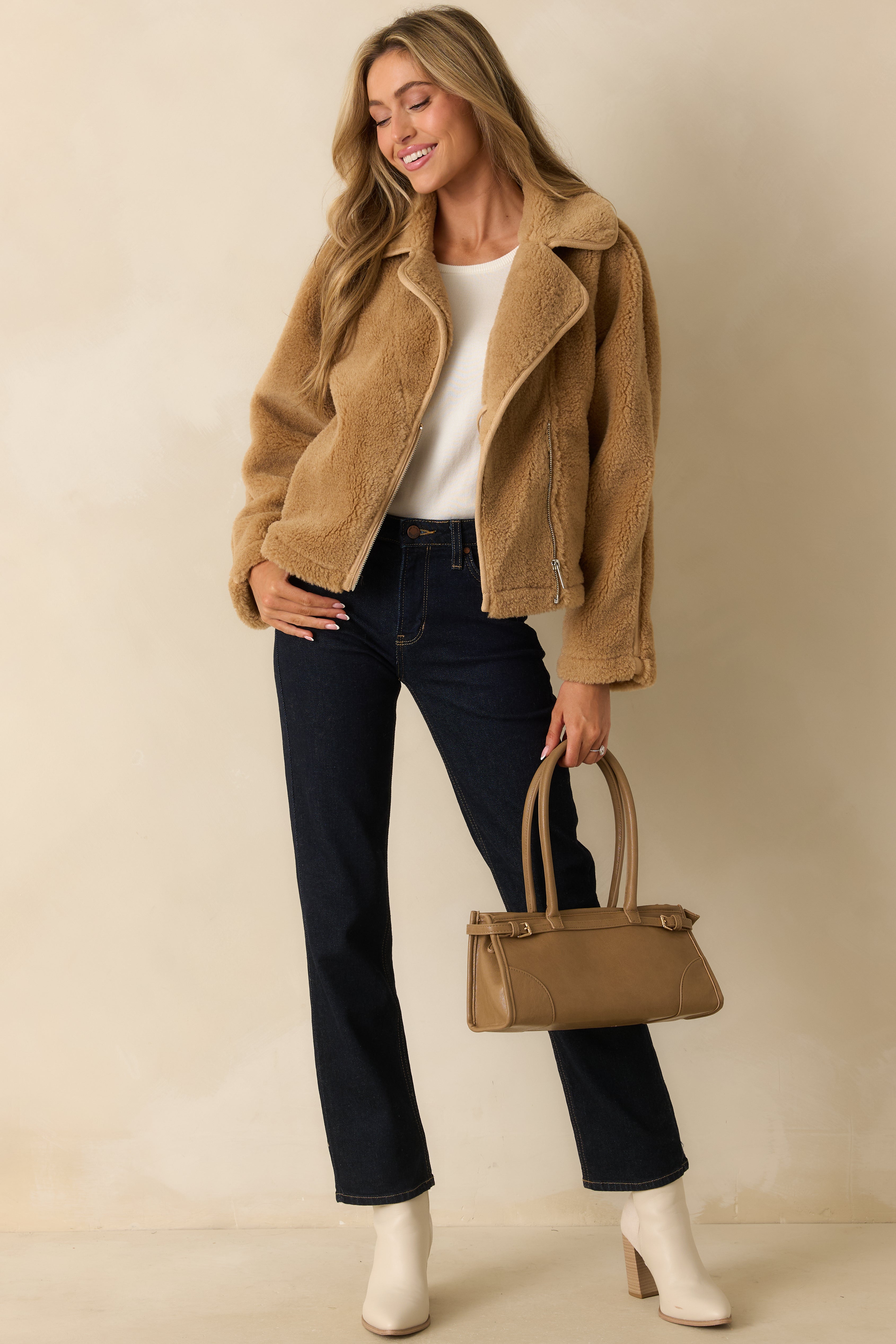 Front view of the tan sherpa jacket featuring a collared neckline, zip-front closure, and long sleeves in soft faux shearling.