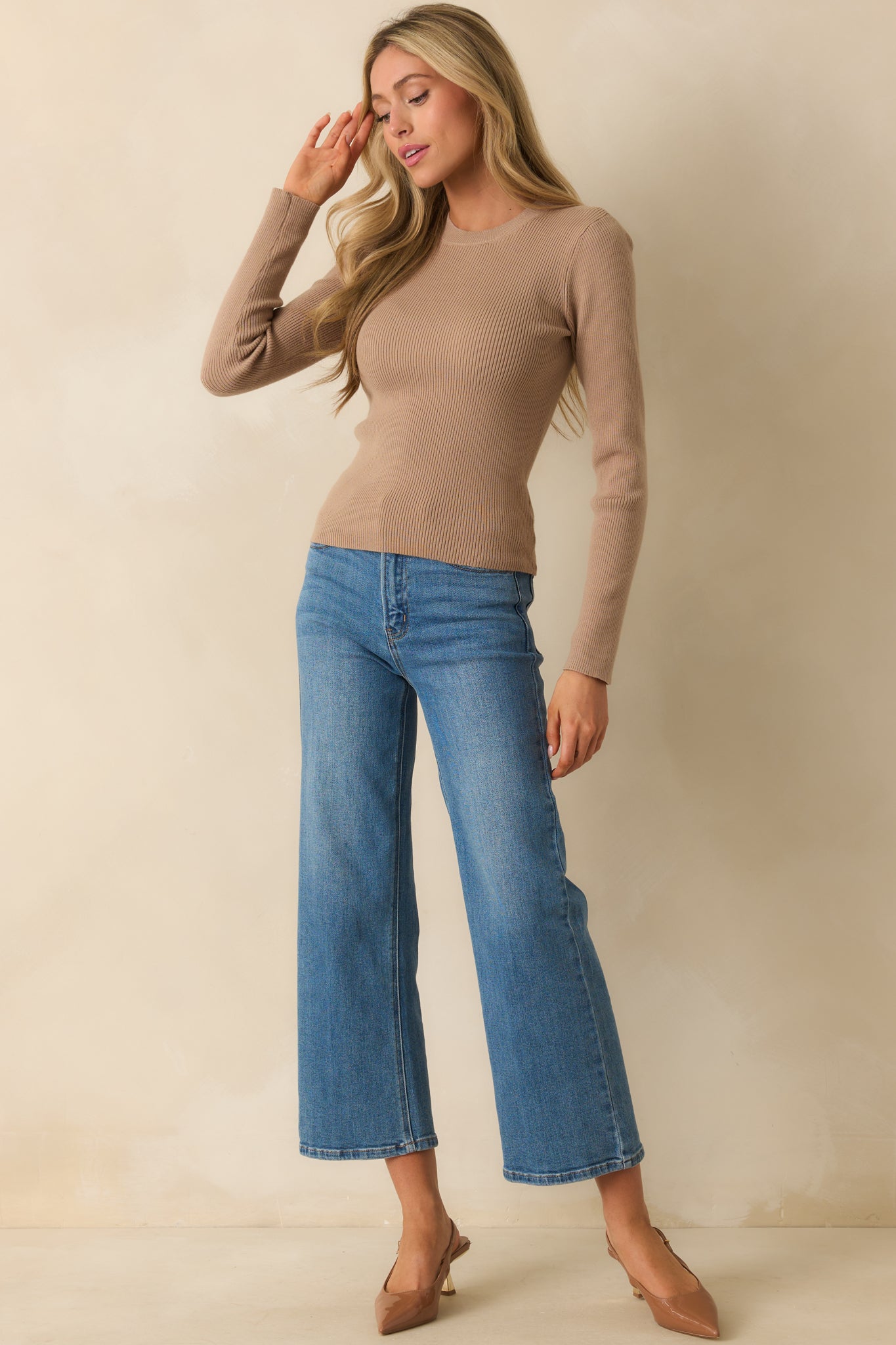 Front view of taupe sweater highlighting long sleeves and classic crew neck.
