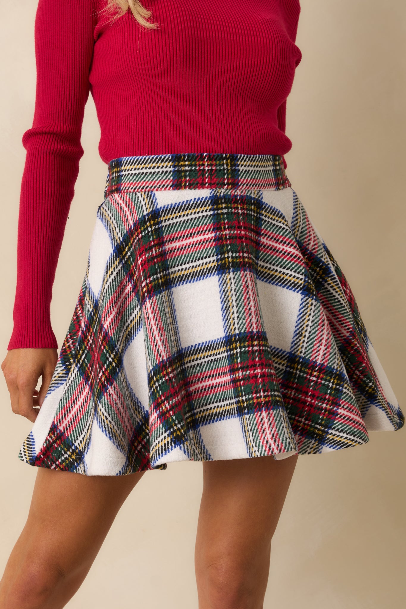 Front view of white multi-color plaid mini skirt with flared A-line silhouette and structured waistband.