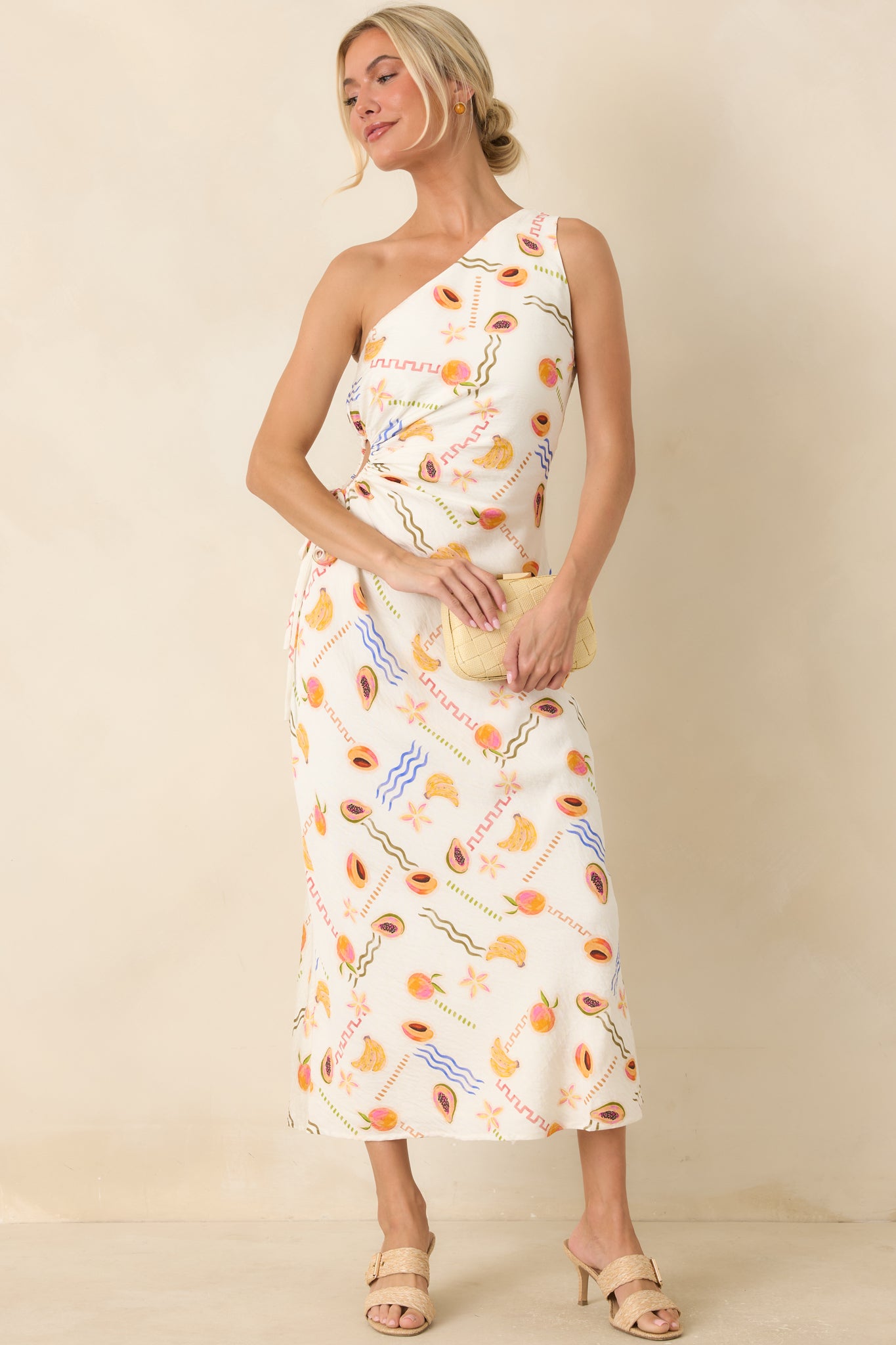 Fruit print viscose maxi dress featuring an asymmetrical one-shoulder neckline, side cutout, and flowing silhouette.