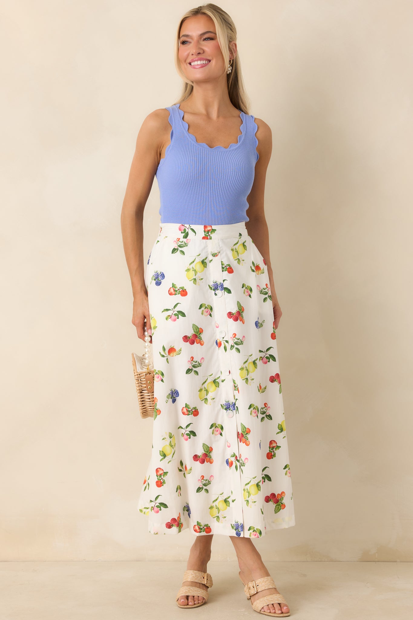 Playful fruit-printed midi skirt featuring elastic back waistband and functional side pockets