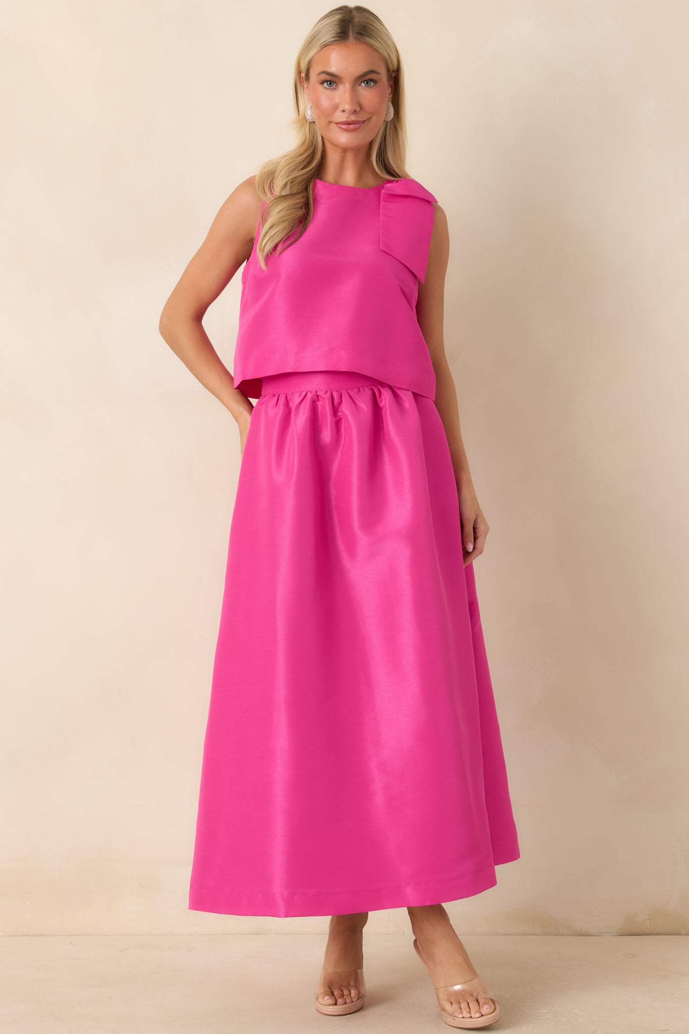 Fuchsia blouse with a boxy fit, elegant shoulder bow detail, and clean straight hem.