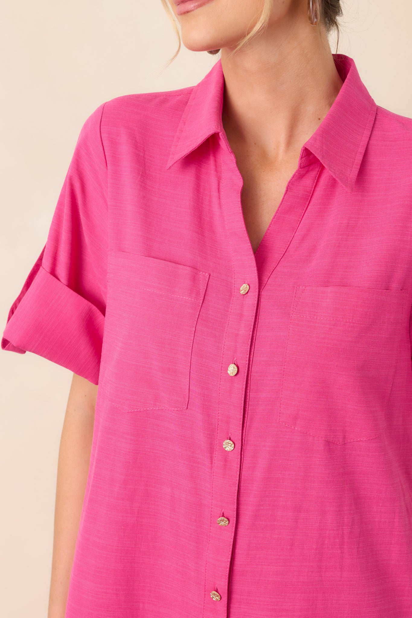 Close-up of the fuchsia shirt dress highlighting the collared neckline, gold-tone buttons, and lightweight cotton texture.