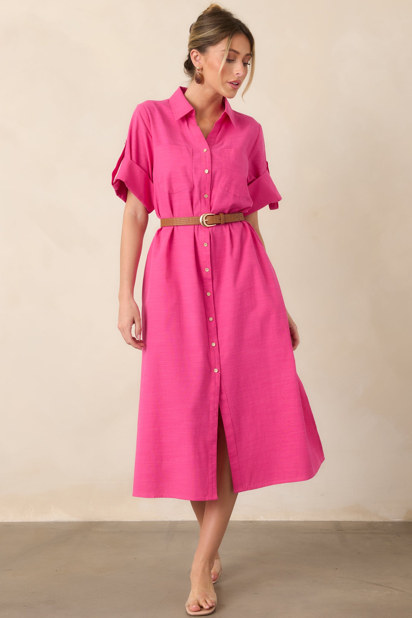 Fuchsia cotton midi shirt dress with a collared neckline, gold-tone button-front closure, long sleeves, and relaxed straight silhouette.
