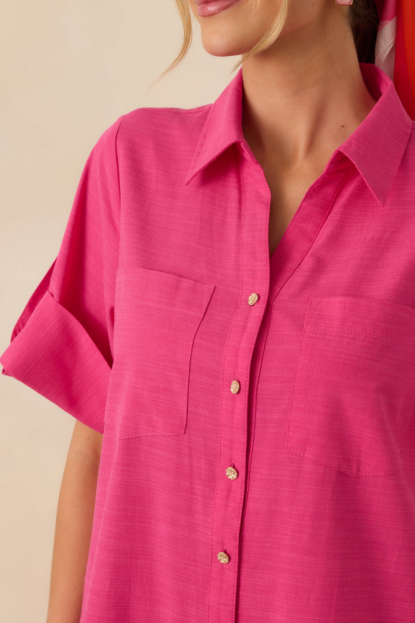 Close-up of the collared neckline and gold-tone button-front closure on the fuchsia cotton midi shirt dress, highlighting fabric texture and button details.