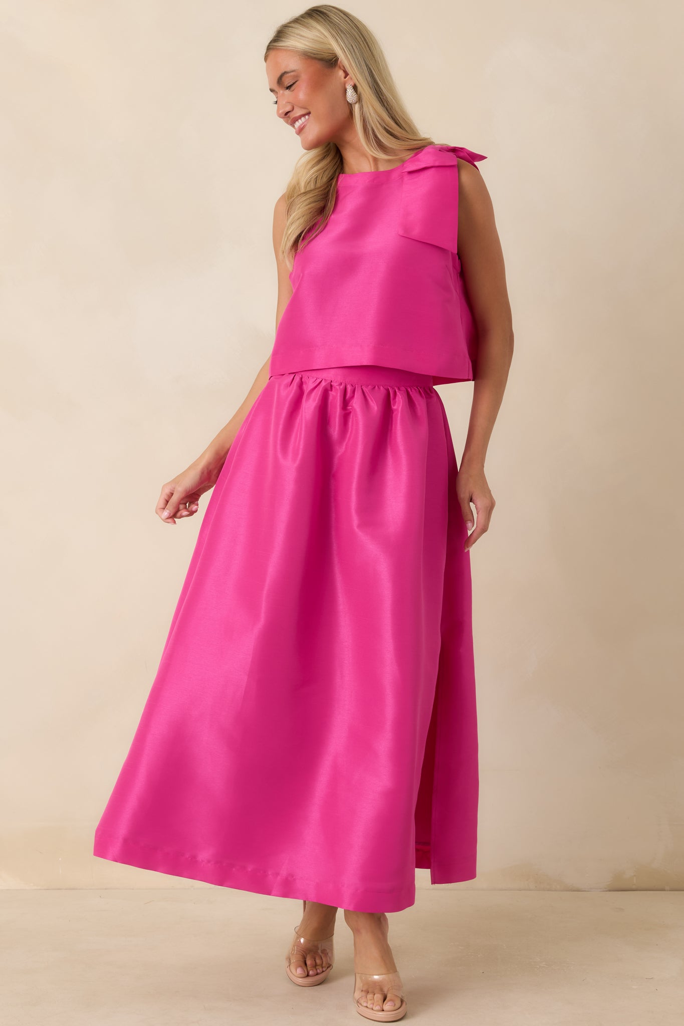Full-length fuchsia skirt with a gathered waistband, smooth woven fabric, and elegant drape.