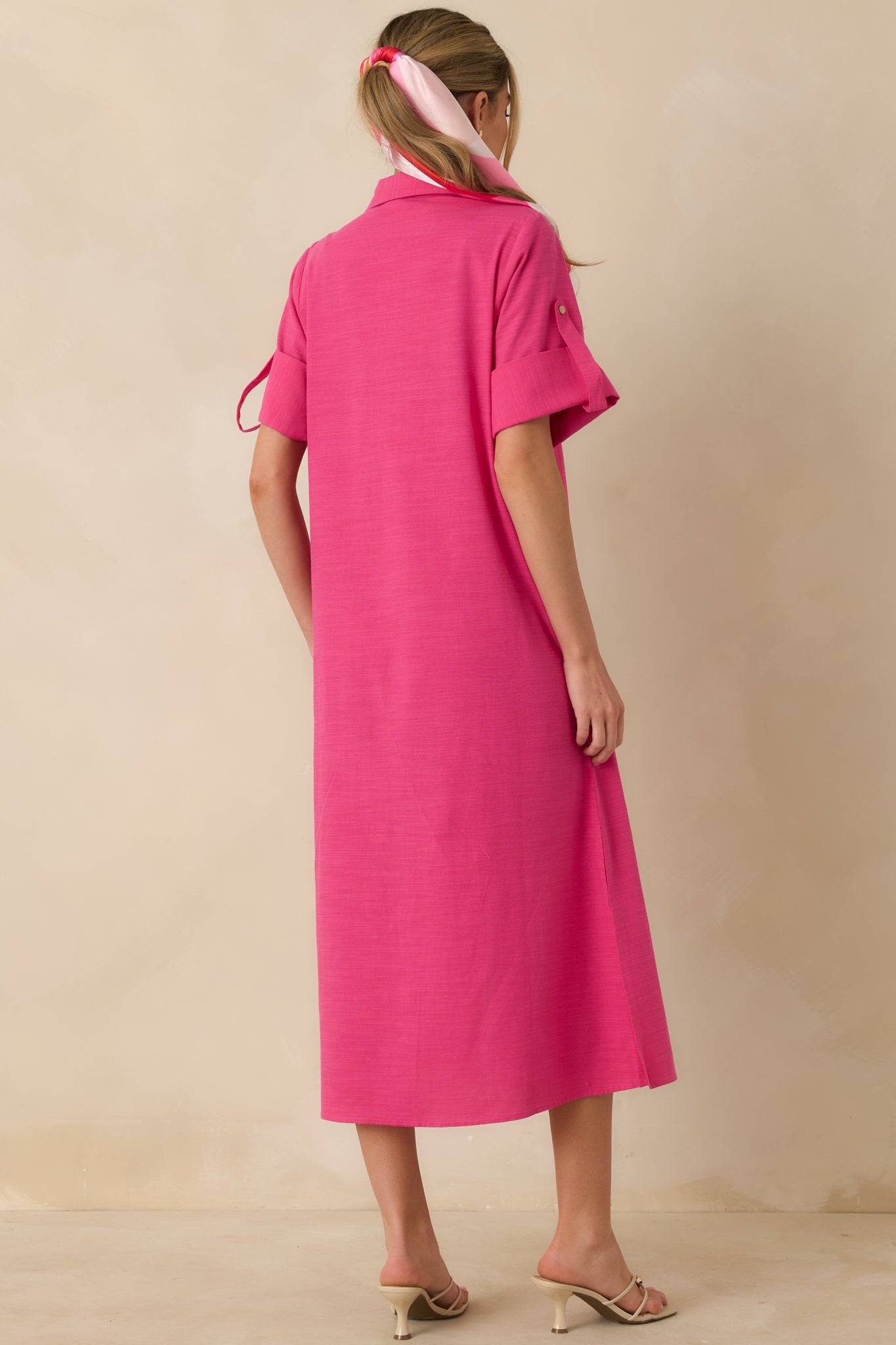 Back view of the fuchsia midi shirt dress showing the straight relaxed silhouette and long sleeves with a lightweight, breathable cotton drape.