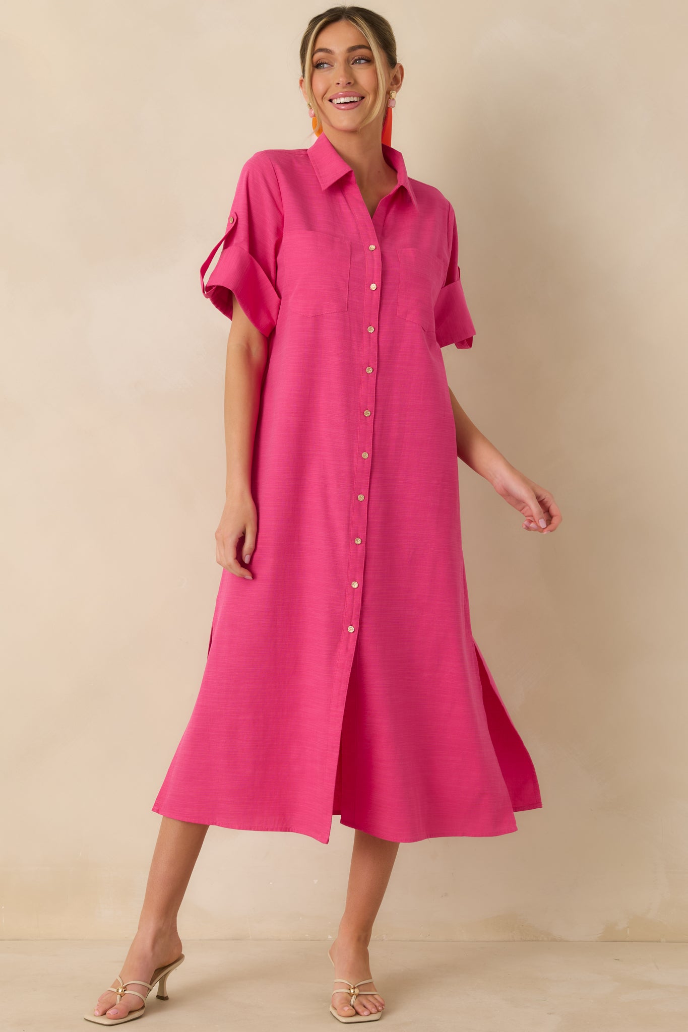 Long-sleeve fuchsia midi shirt dress featuring a breathable cotton fabric, collared neckline, and full button-front closure with gold-tone buttons.