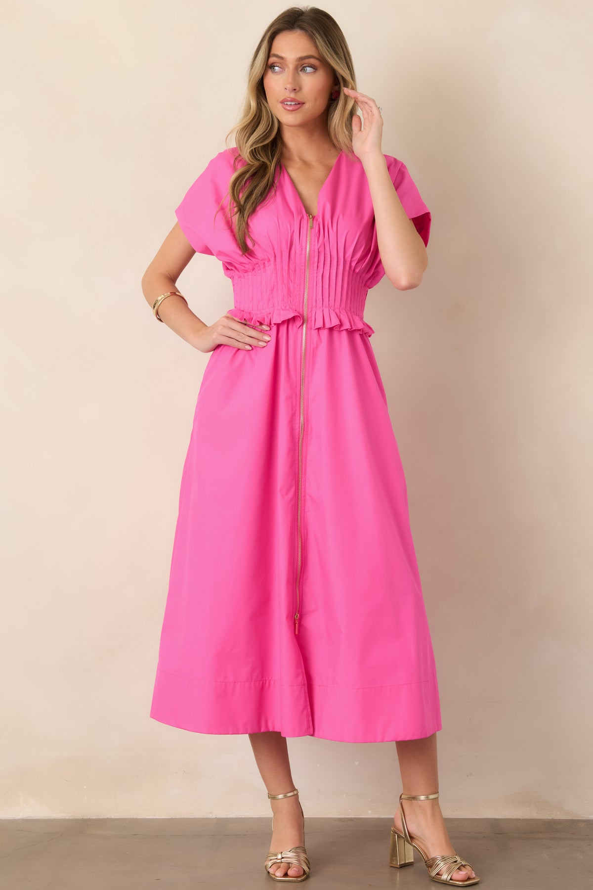 Vibrant fuchsia maxi dress featuring a ruffle-trimmed smocked waist, short sleeves, functional side pockets, and flowing A-line silhouette.