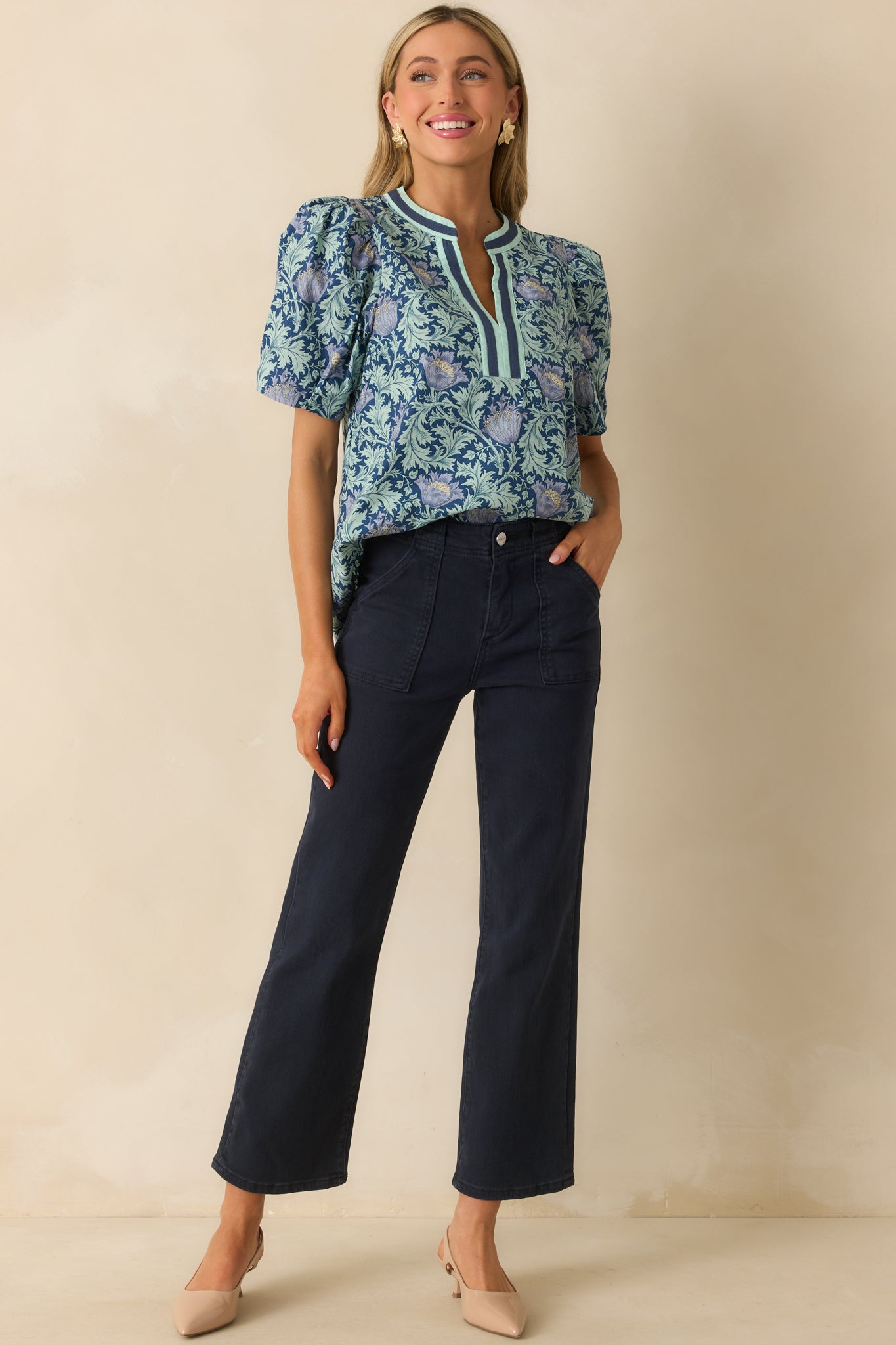 A full body angle showing the short puff sleeves and vibrant floral design throughout.