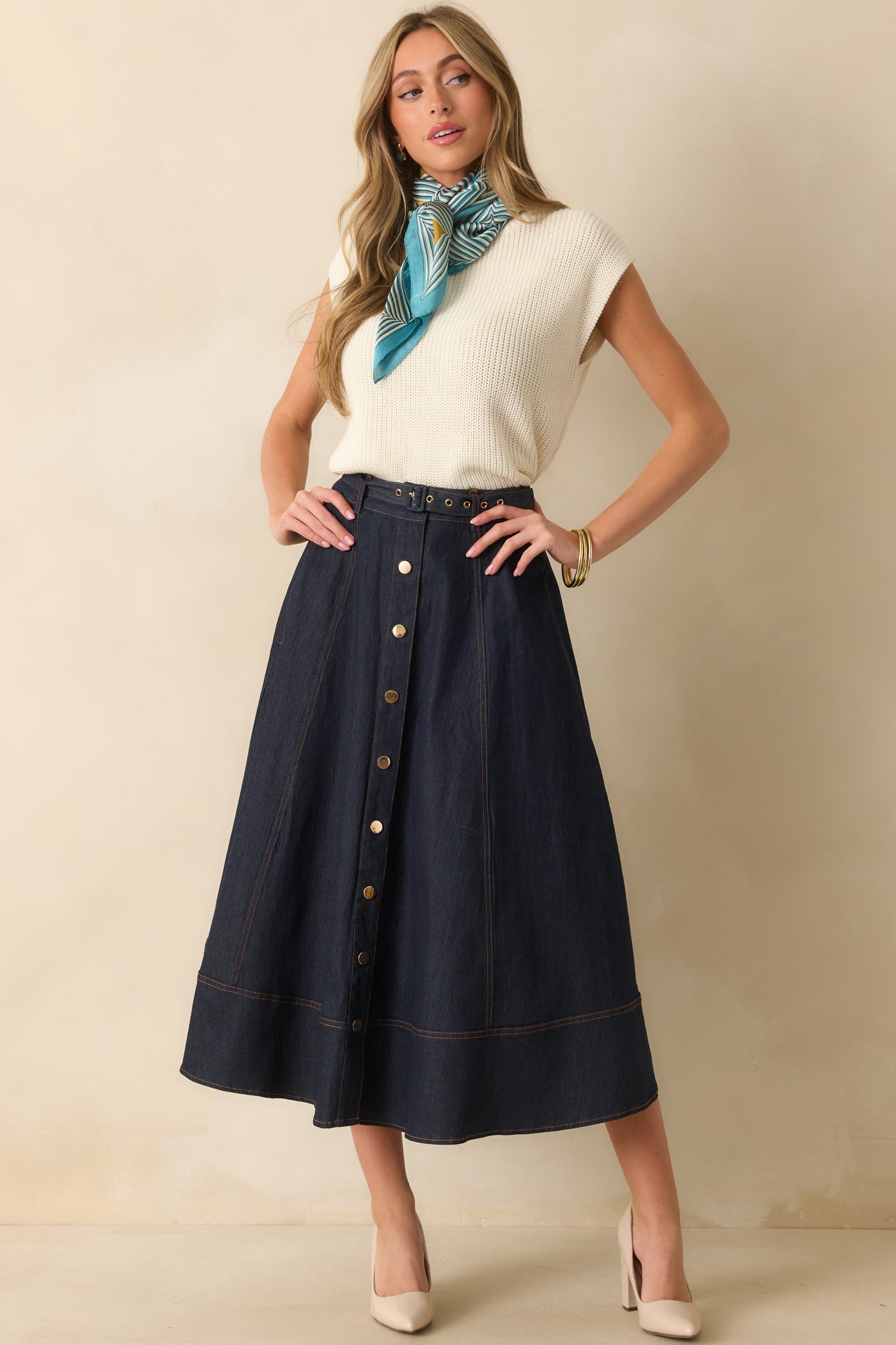 A full body view of the dark wash skirt featuring a high rise waist and functional snap button front.
