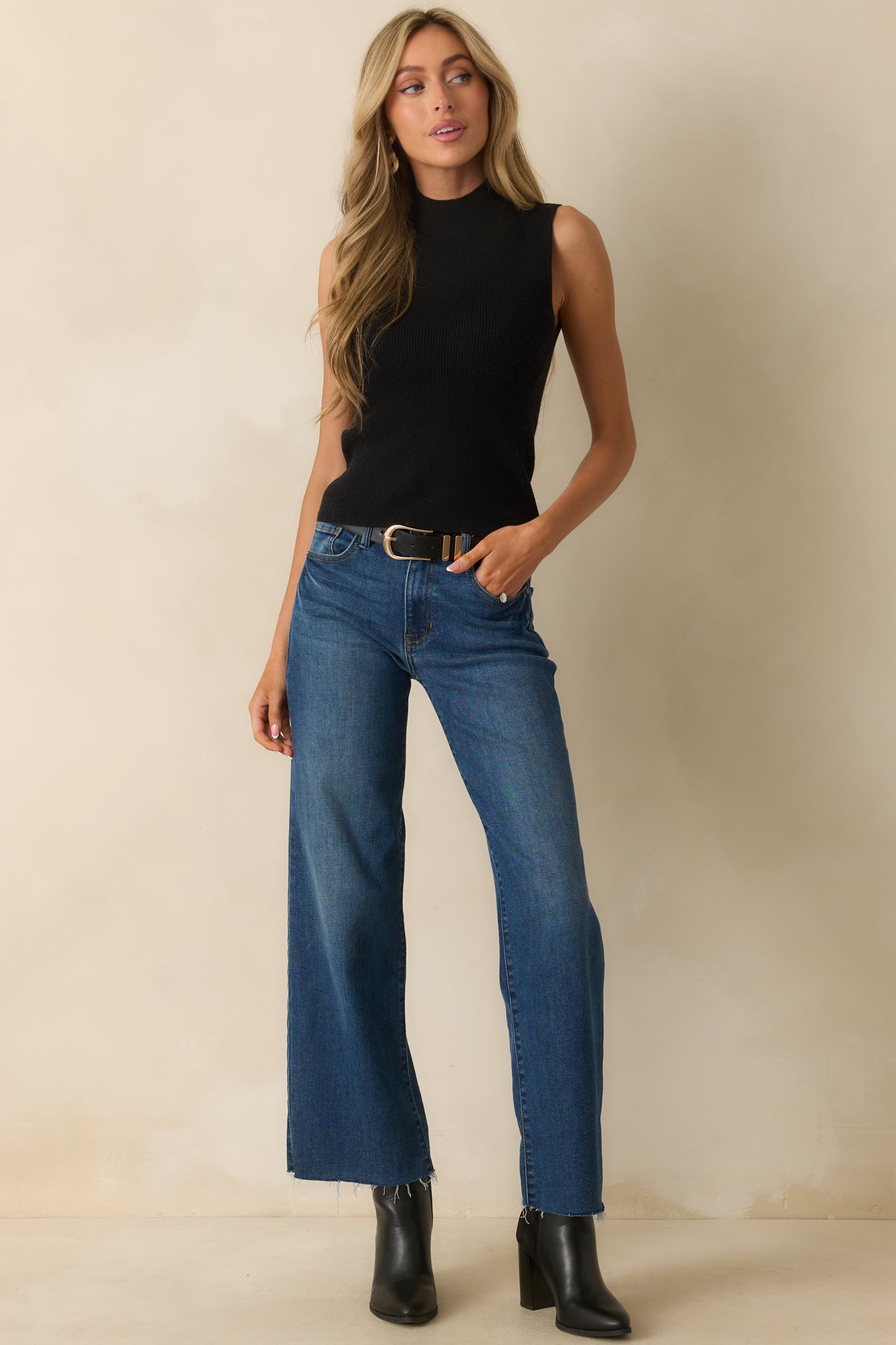 Full body front view of the black sleeveless top with a mock neckline and fitted ribbed design.