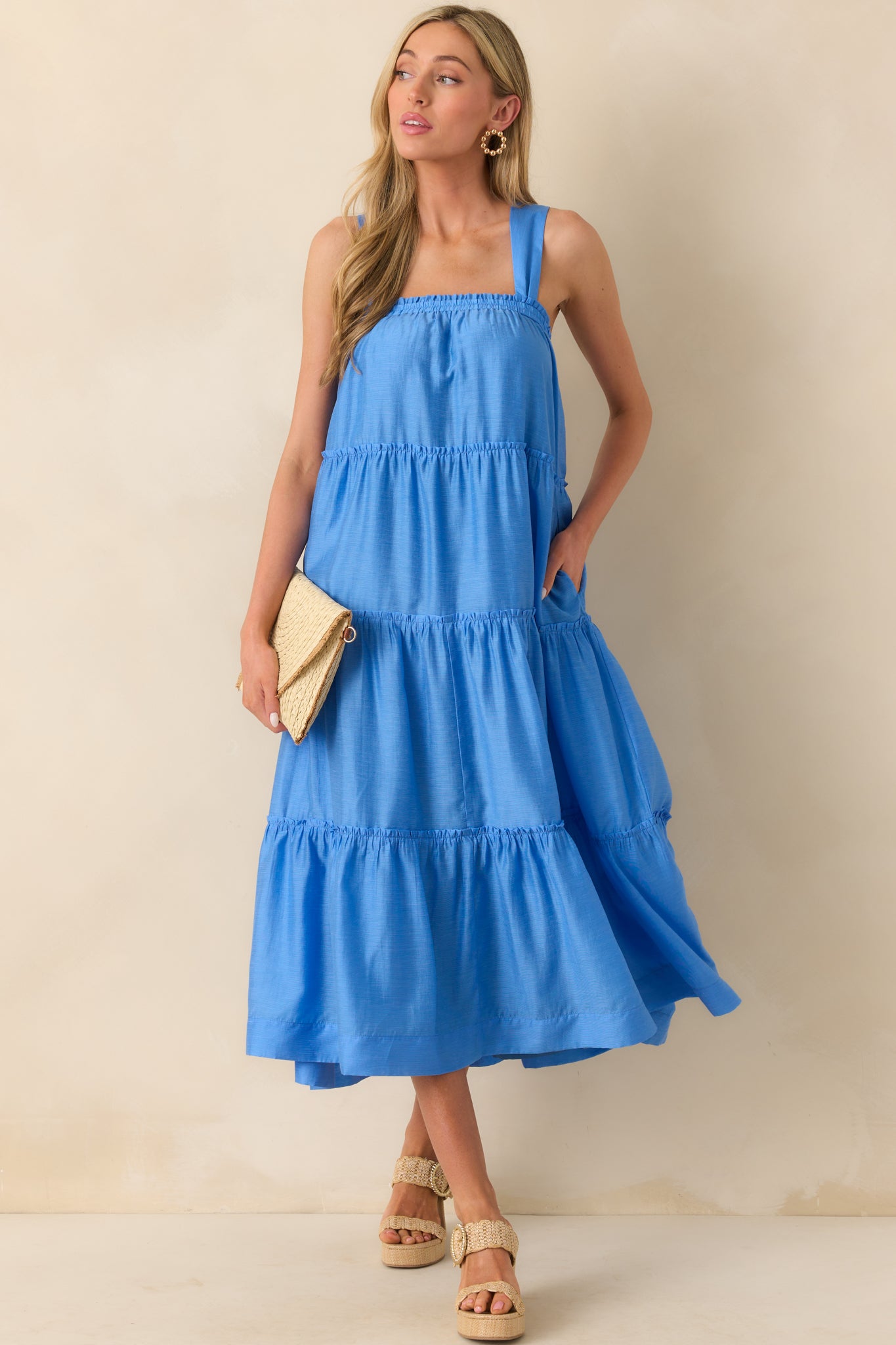 Full body front view of the blue midi dress showcasing its square elastic neckline, wide straps, and loose, relaxed fit.