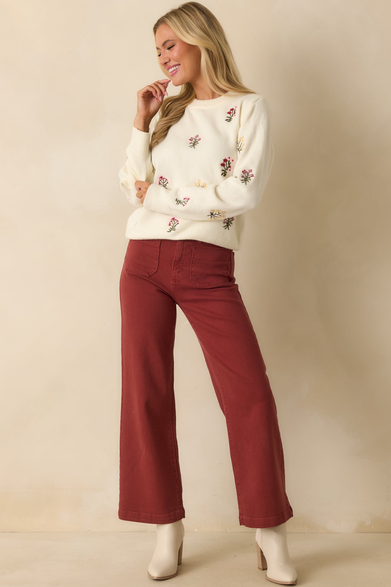 Full body front view highlighting the overall floral embroidery and subtle bead detailing across the sweater.