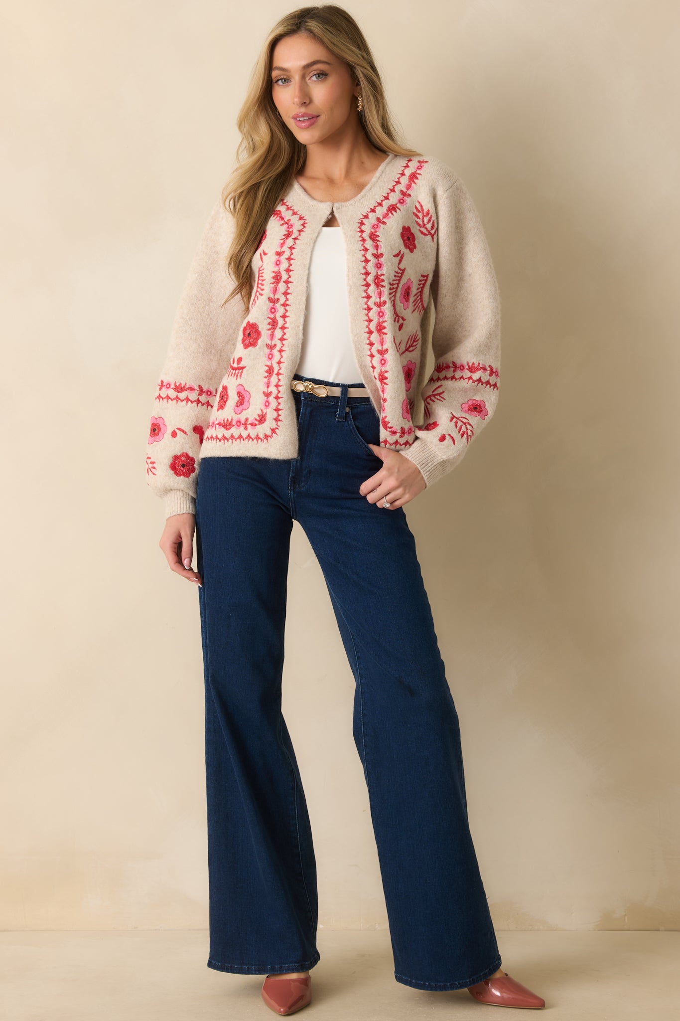 Full body front view of an oatmeal cardigan with red and pink floral embroidery, long sleeves, and single front clasp closure.