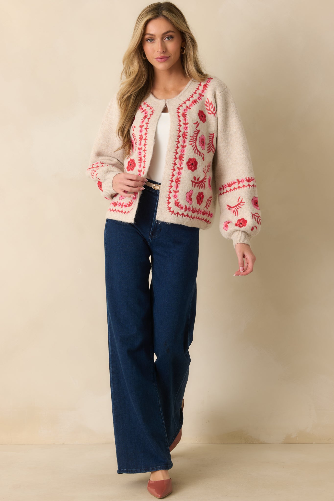 Full body front view highlighting the relaxed fit and ribbed cuffs of the embroidered cardigan.