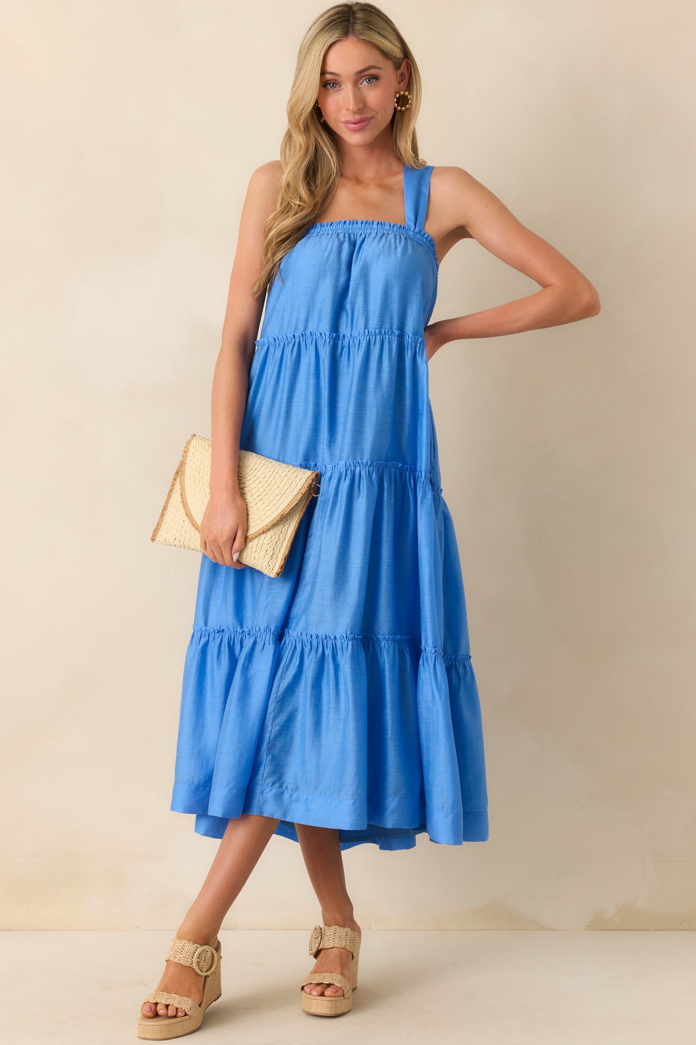 Full body image highlighting the tiered ruffle design along the skirt, functional pockets, and smooth full blue lining.